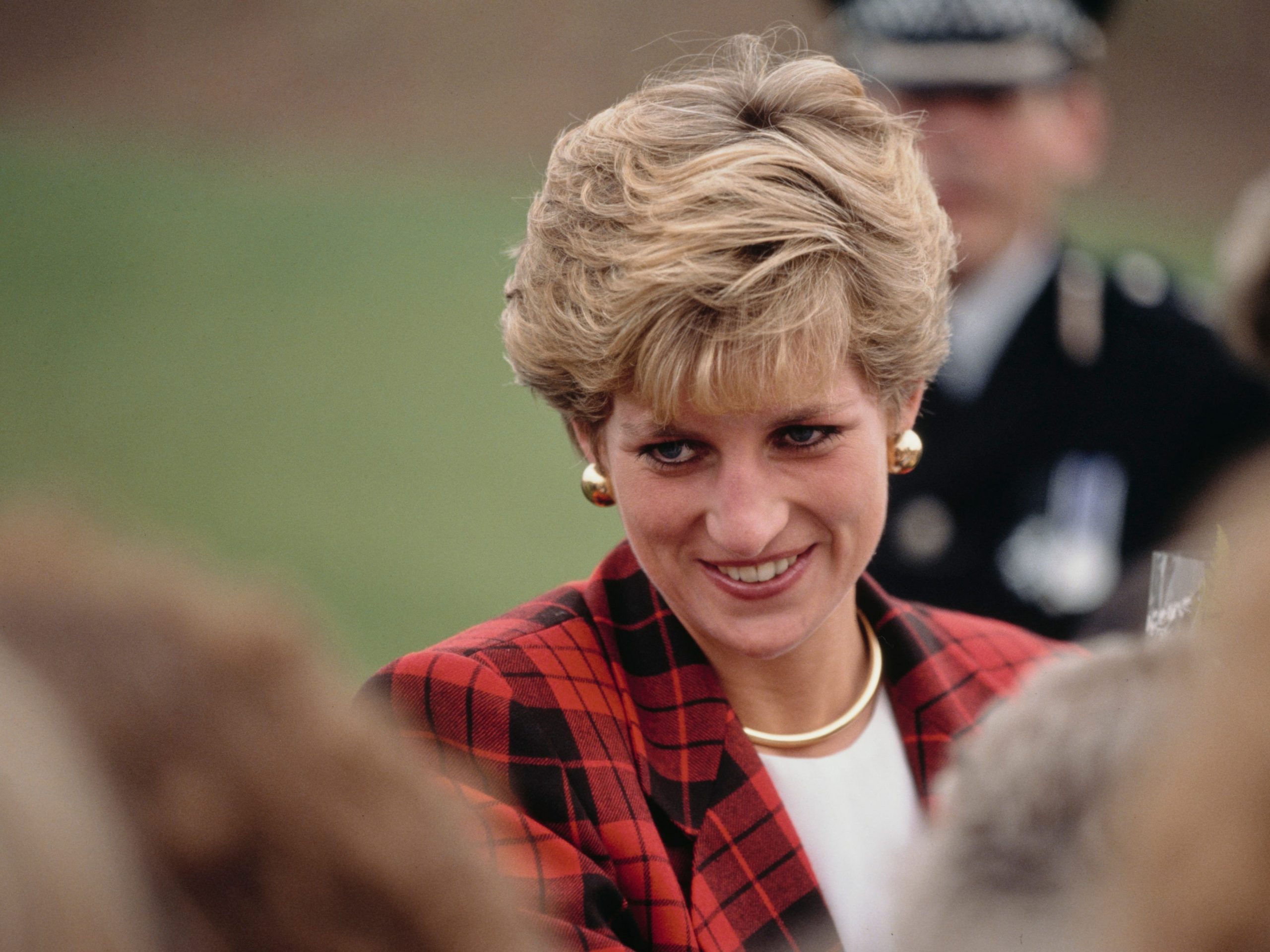 Diana, Princess of Wales (1961 - 1997) visits Tenterden in Kent, 18th October 1990. She is wearing a red and black checked suit by Escada.