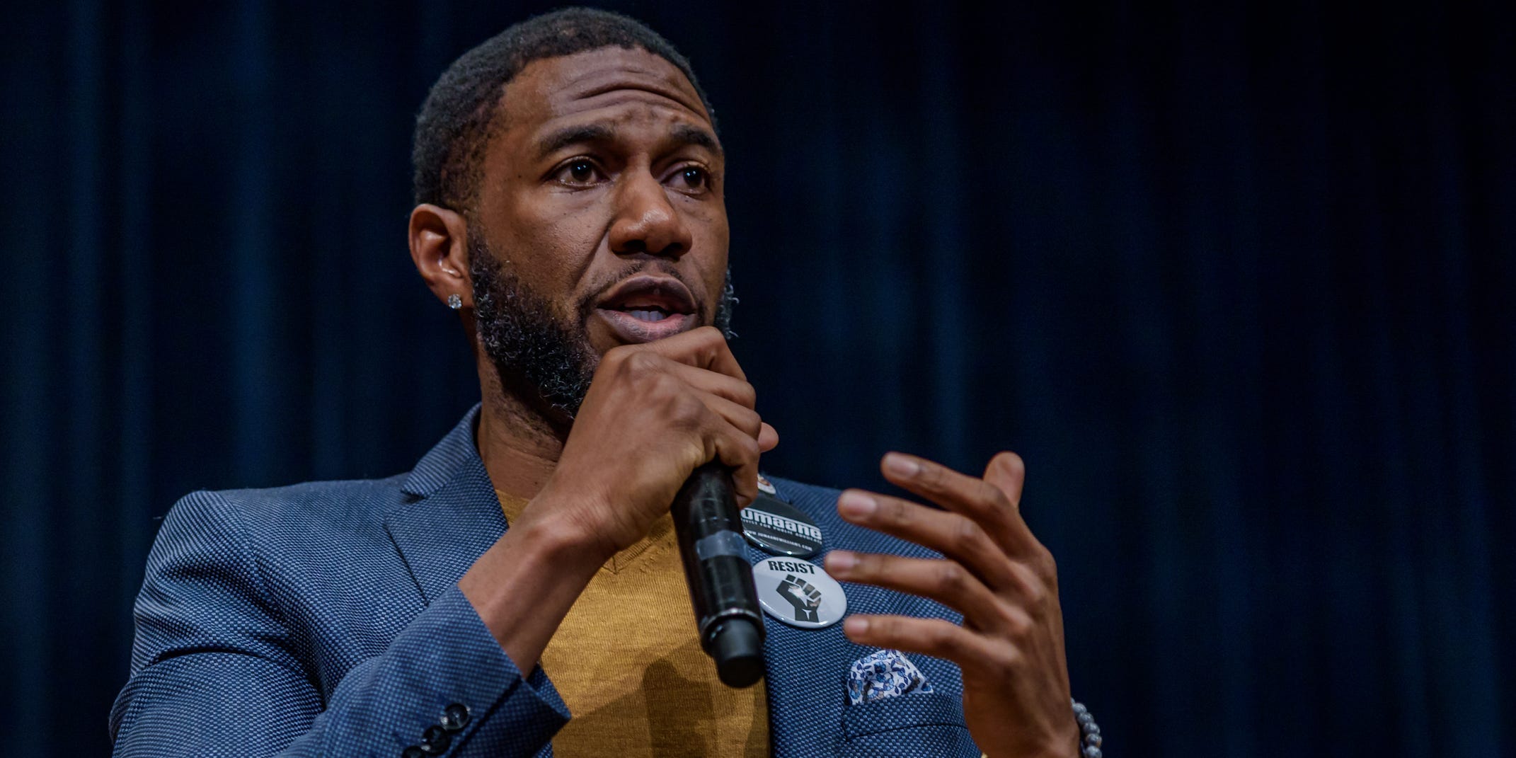 New York City Public Advocate Candidate Jumaane Williams speaks with a beige turtleneck under a blue blazer.