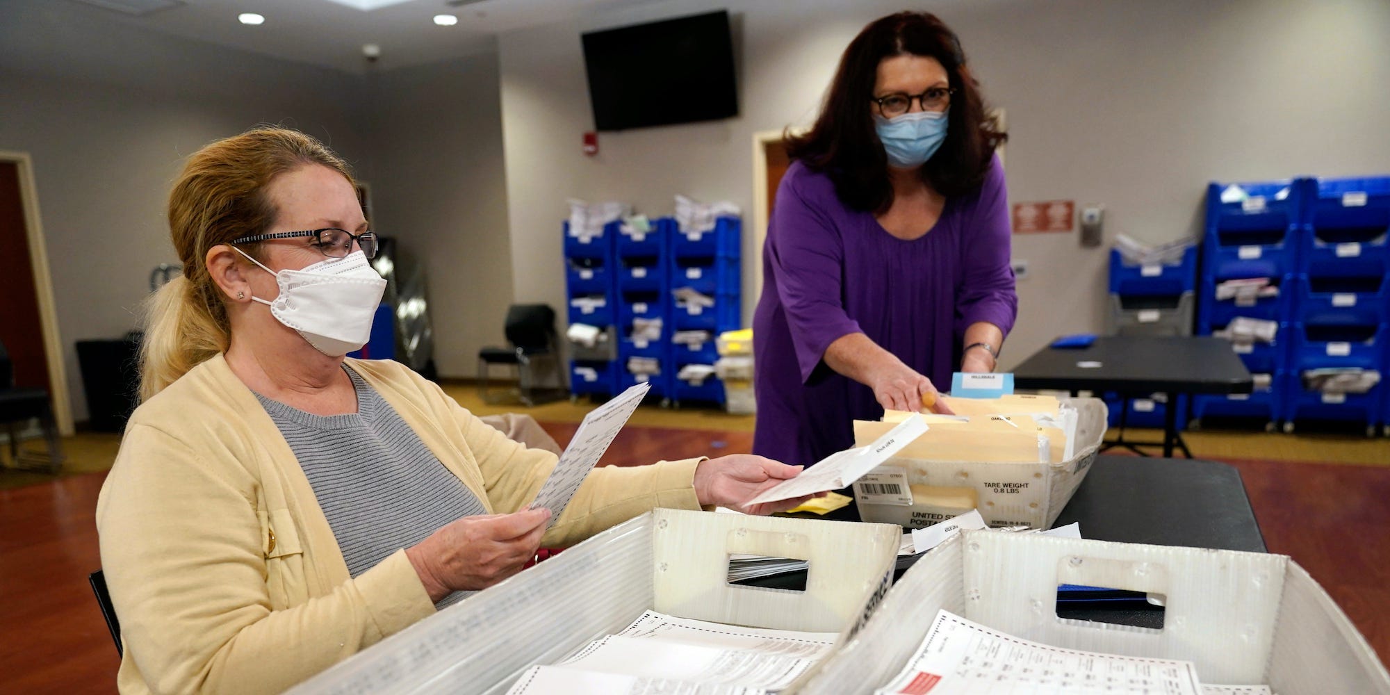 Board worker Ann Carlette, left, processes and double-checks mail-in ballots for Bergen County in Hackensack, N.J., Wednesday, Nov. 3, 2021.