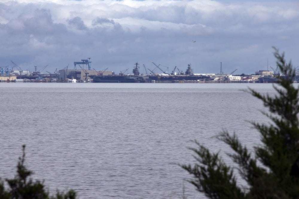 USS Gerald R. Ford (CVN 78) prepares to moor next to Pre-Commissioning Unit John F. Kennedy (CVN 79) following a transit from Naval Station Norfolk to Newport News Shipyard, Virginia, Aug. 20, 2021