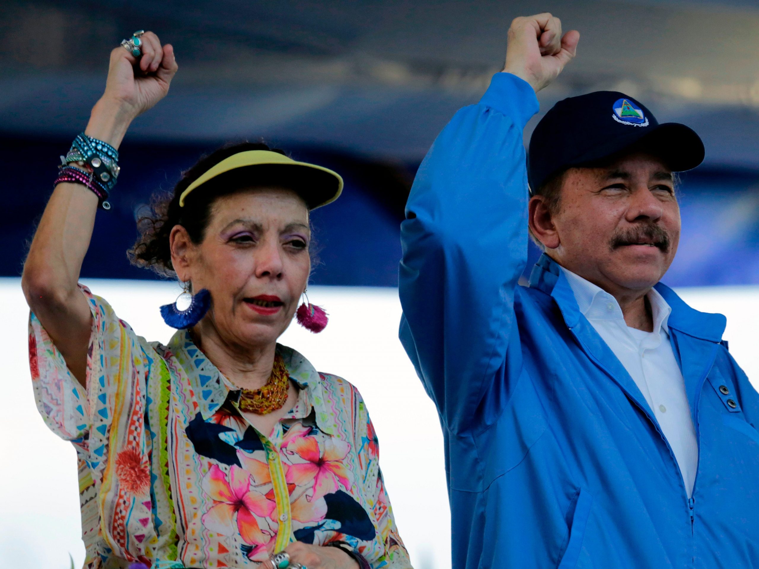 Nicaraguan President Daniel Ortega and his wife, Vice-President Rosario Murillo, raise their fists during the commemoration of the 51st anniversary of the Pancasan guerrilla campaign in Managua, on August 29, 2018.