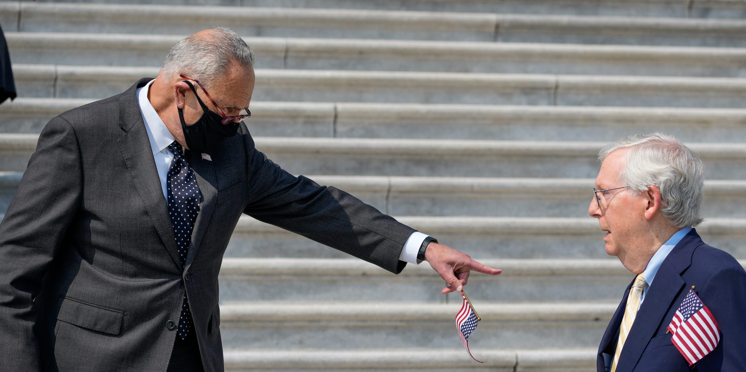 Senate Majority Leader Chuck Schumer (D-NY) points at Senate Minority Leader Mitch McConnell as they arrive for a remembrance ceremony marking the 20th anniversary of the 9/11 terror attacks on the steps of the U.S. Capitol, on September 13, 2021 in Washington, DC.