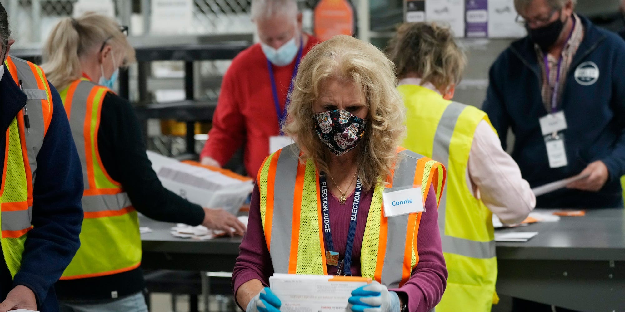 Election judges process early ballots in the Jefferson County elections division, Tuesday, Oct. 26, 2021, in Golden, Colo.