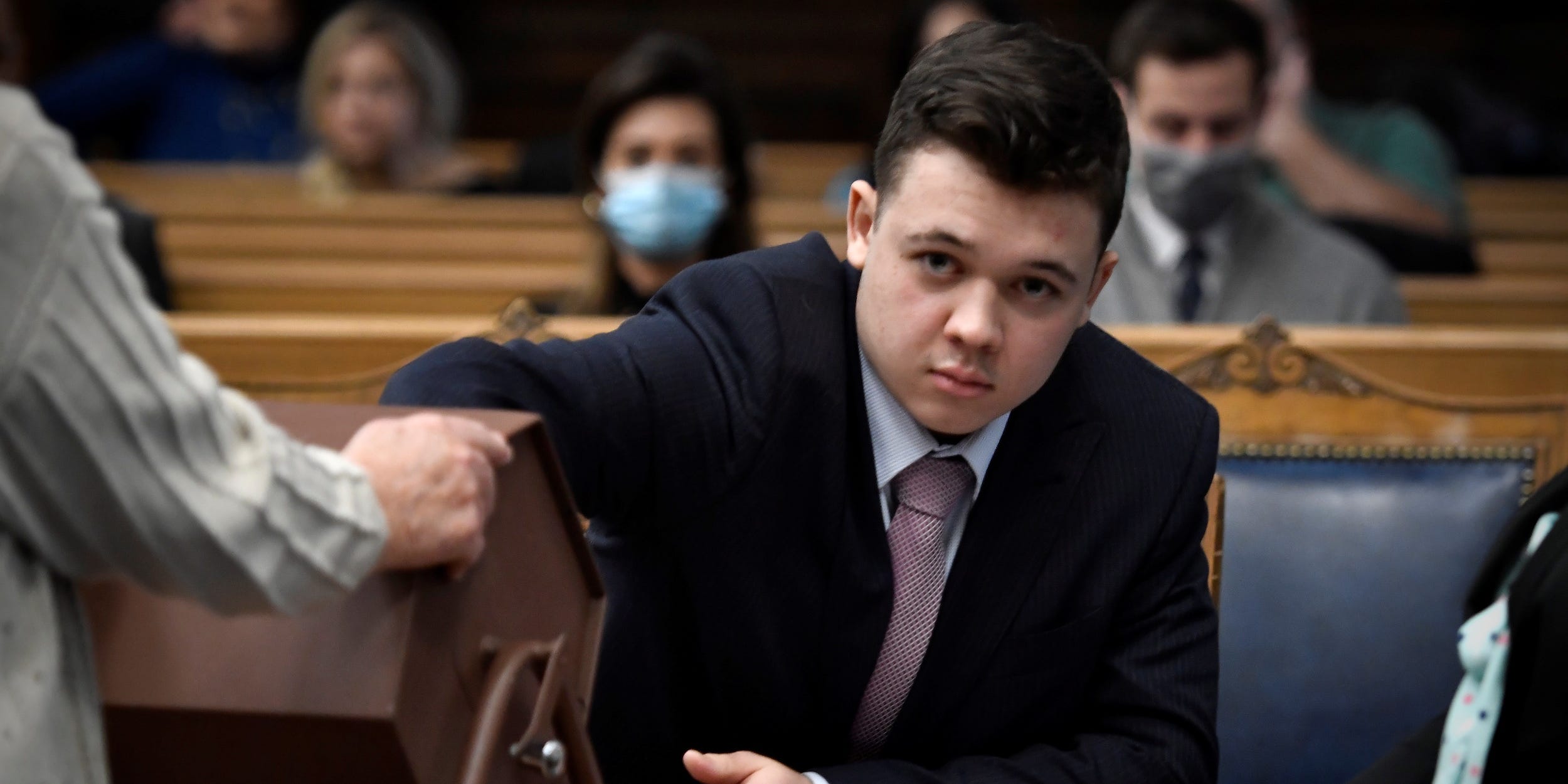 Kyle Rittenhouse pulls numbers of jurors out of a tumbler during his trail at the Kenosha County Courthouse in Kenosha, Wisconsin, U.S., November 16, 2021