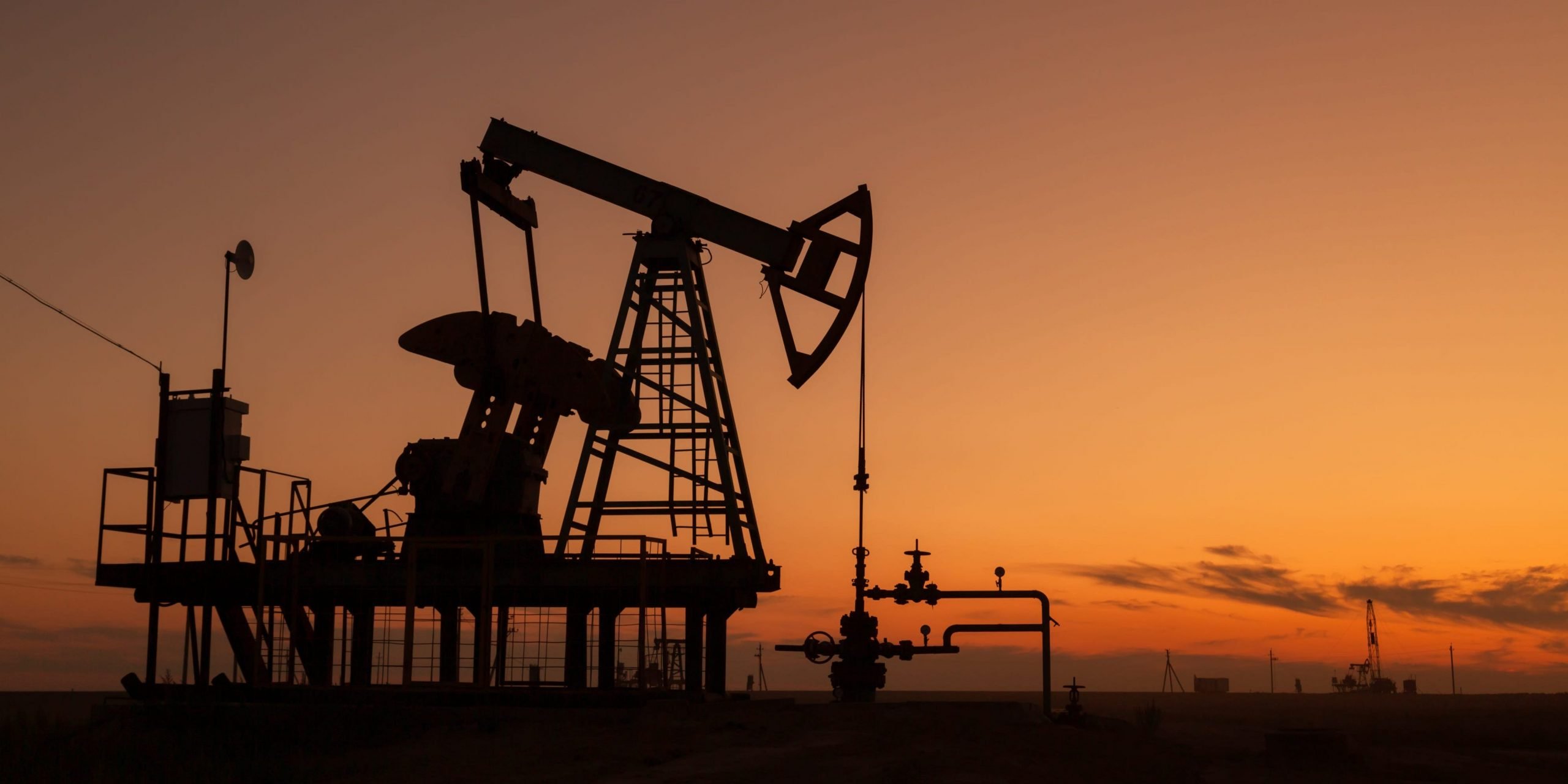 Oil pumps at sunset, industrial oil pumps equipment.