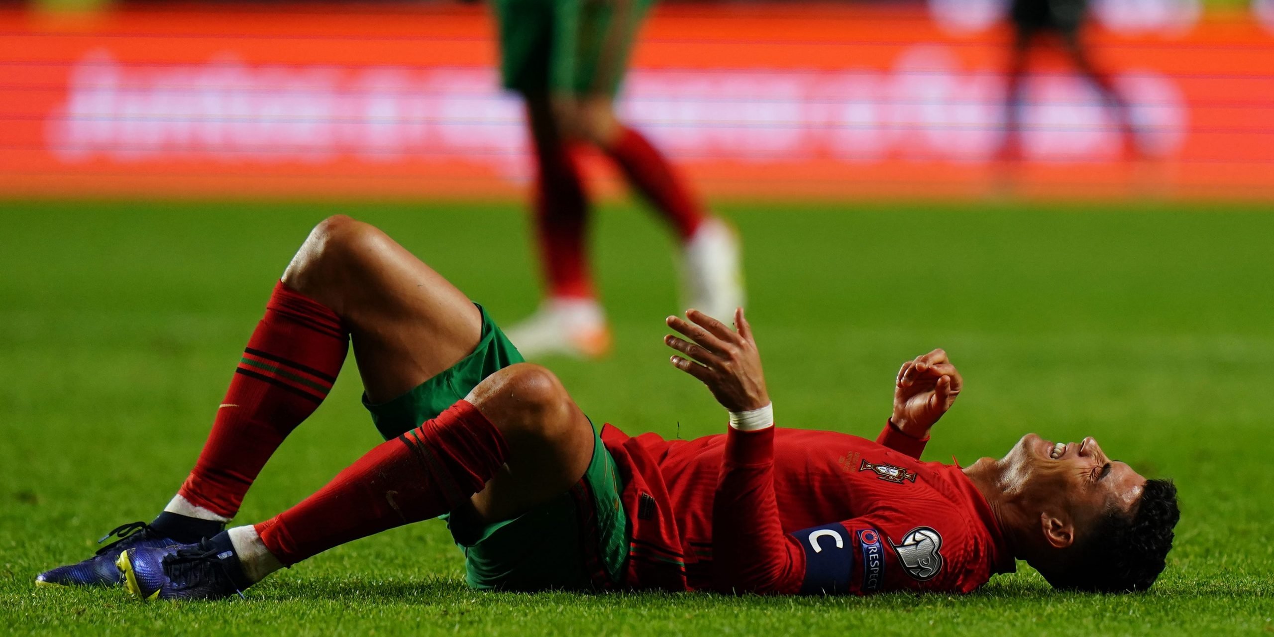 Cristiano Ronaldo lies on the pitch after losing to Serbia in a World Cup qualifier.