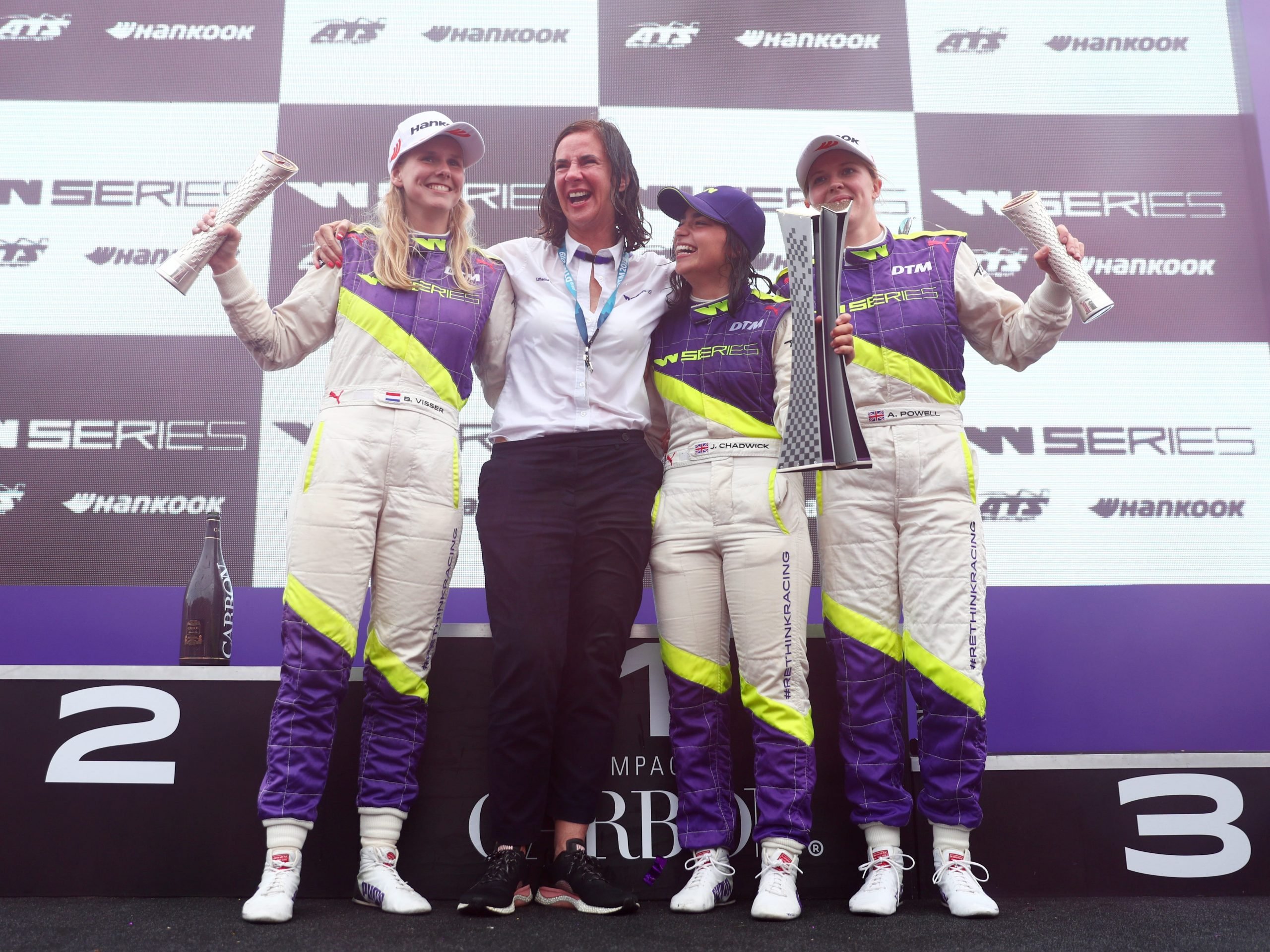 Jamie Chadwick of Great Britain celebrates on the podium with W Series CEO, Catherine Bond Muir