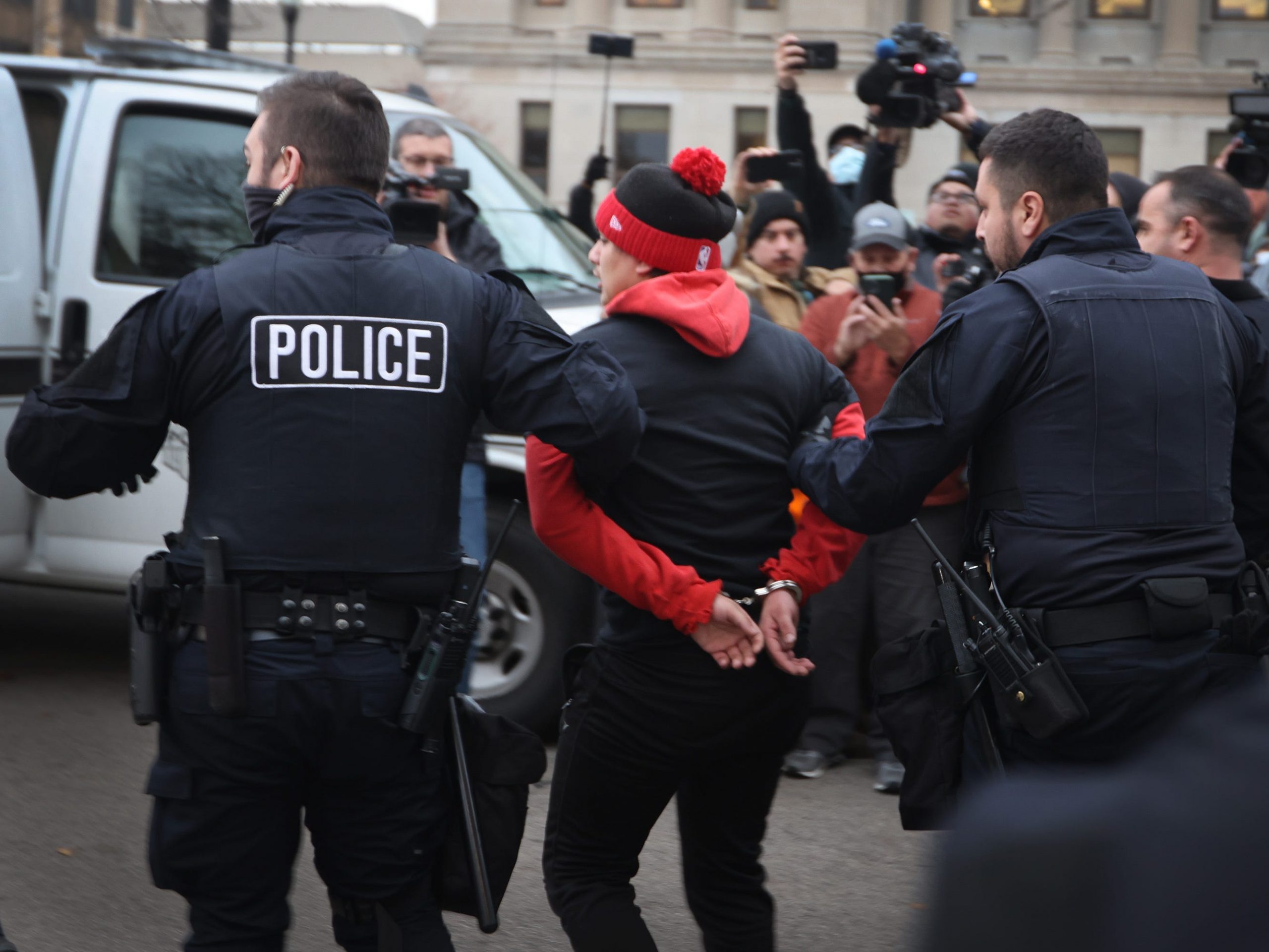 A demonstrator is arrested outside of the Kenosha County Courthouse as the jury deliberates in the trial of Kyle Rittenhouse on November 17, 2021.