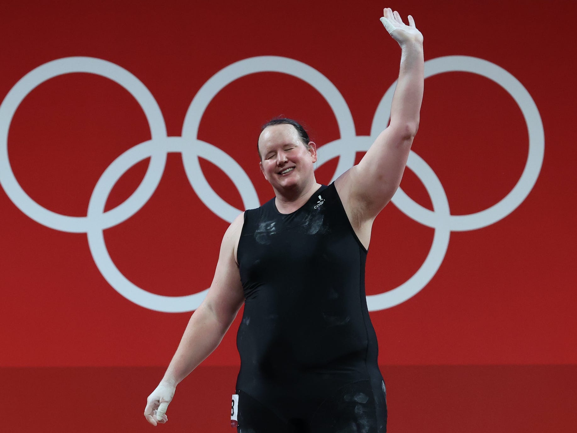 Laurel Hubbard, of New Zealand, waves during the weightlifting event at the Olympic Games in Tokyo.