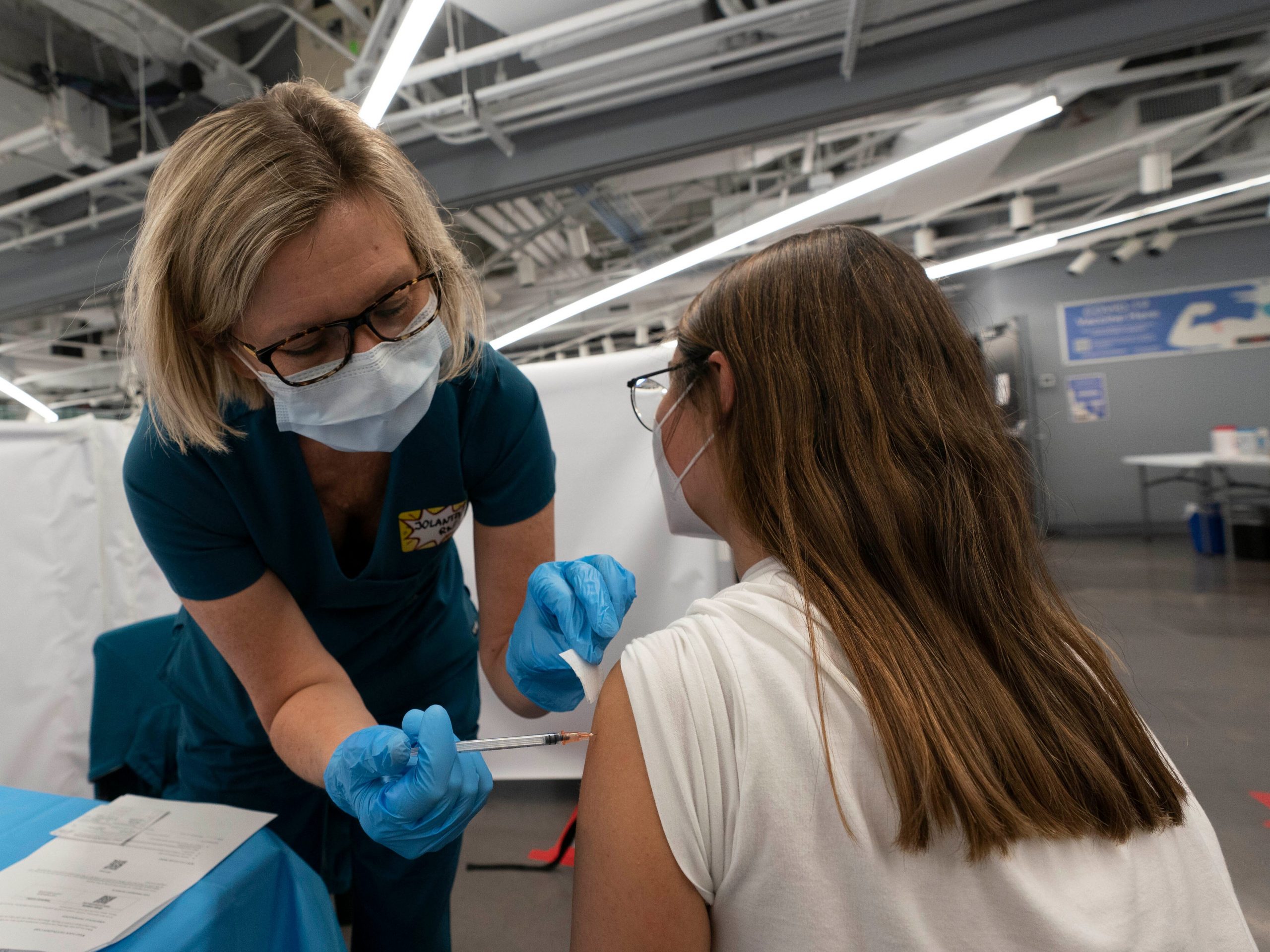 A New York woman receives a Pfizer COVID-19 vaccination.