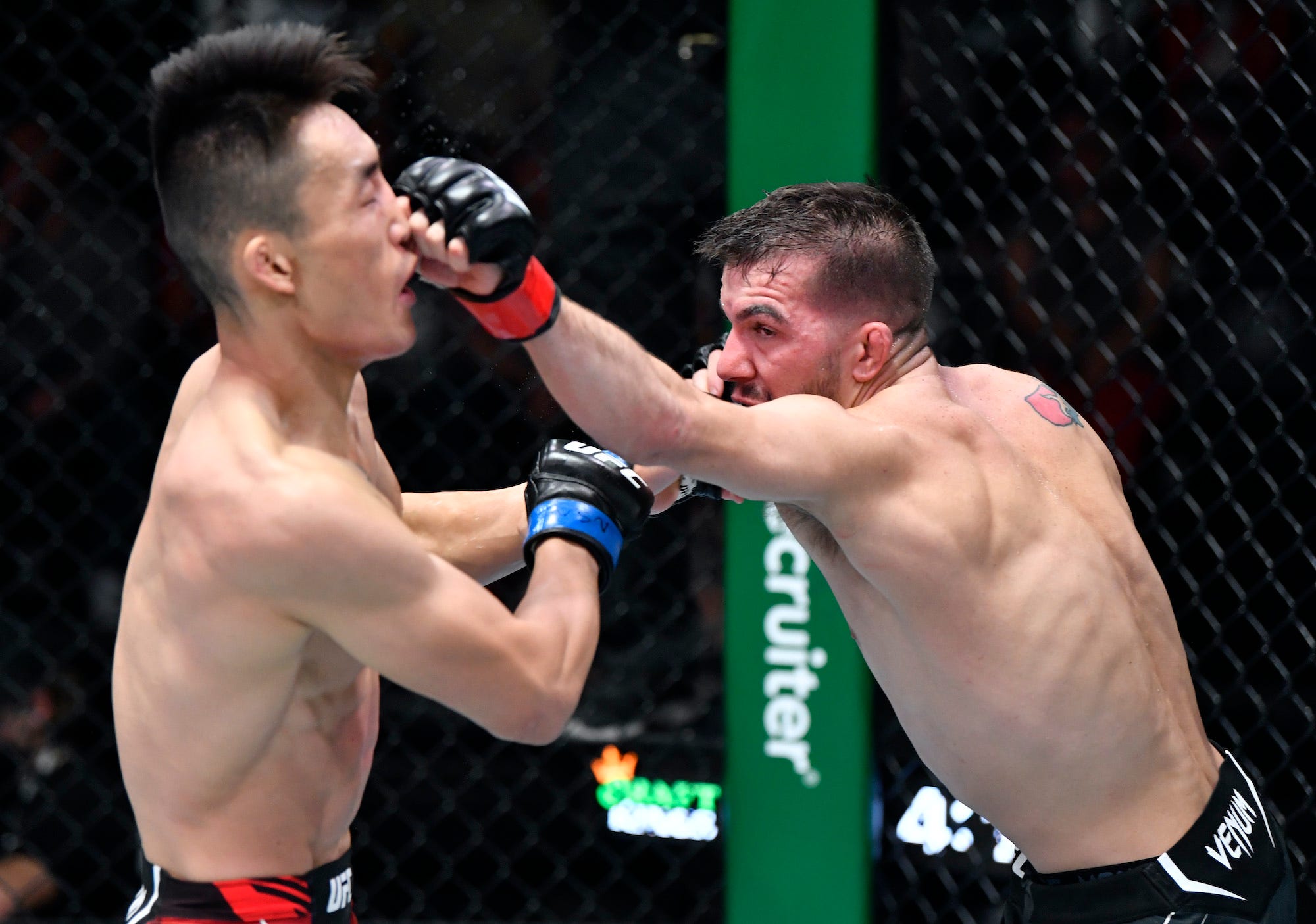 America's Cody Durden punches Aoriqileng of China.