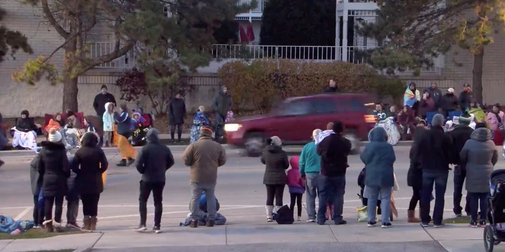 A red SUV speeds past attendees moments before plowing into a crowd at a Christmas parade in Waukesha, Wisconsin, US, in this still image taken from a November 21, 2021 social media video.