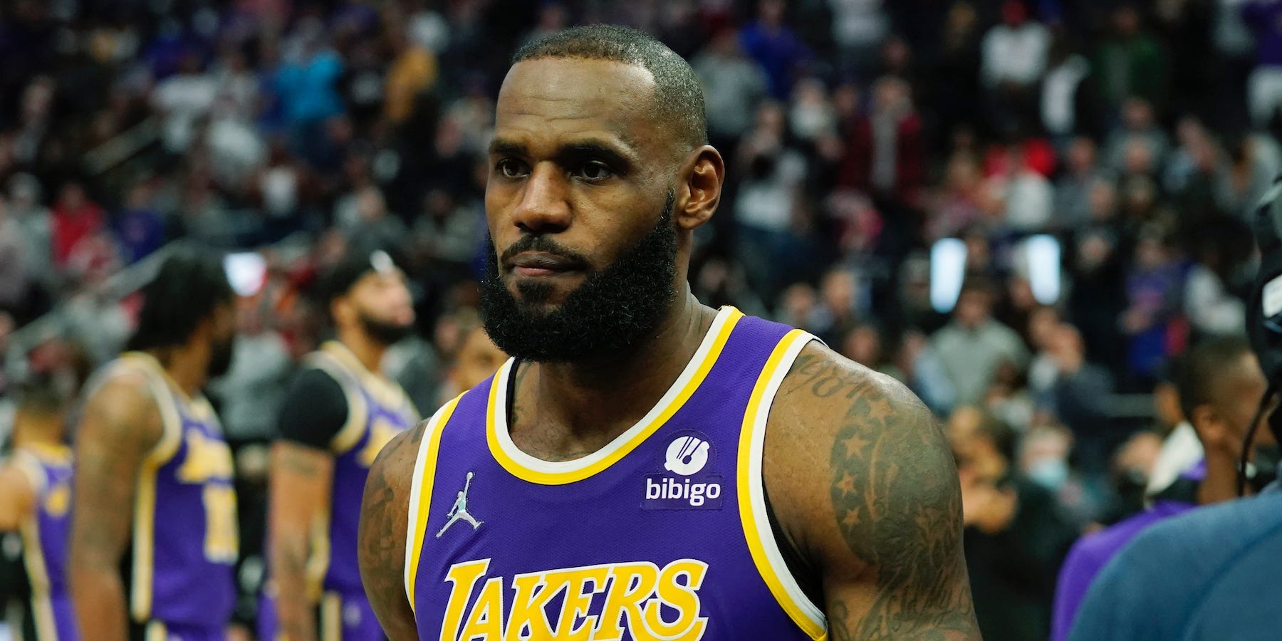 LeBron James looks on as he walks off the court after being ejected.