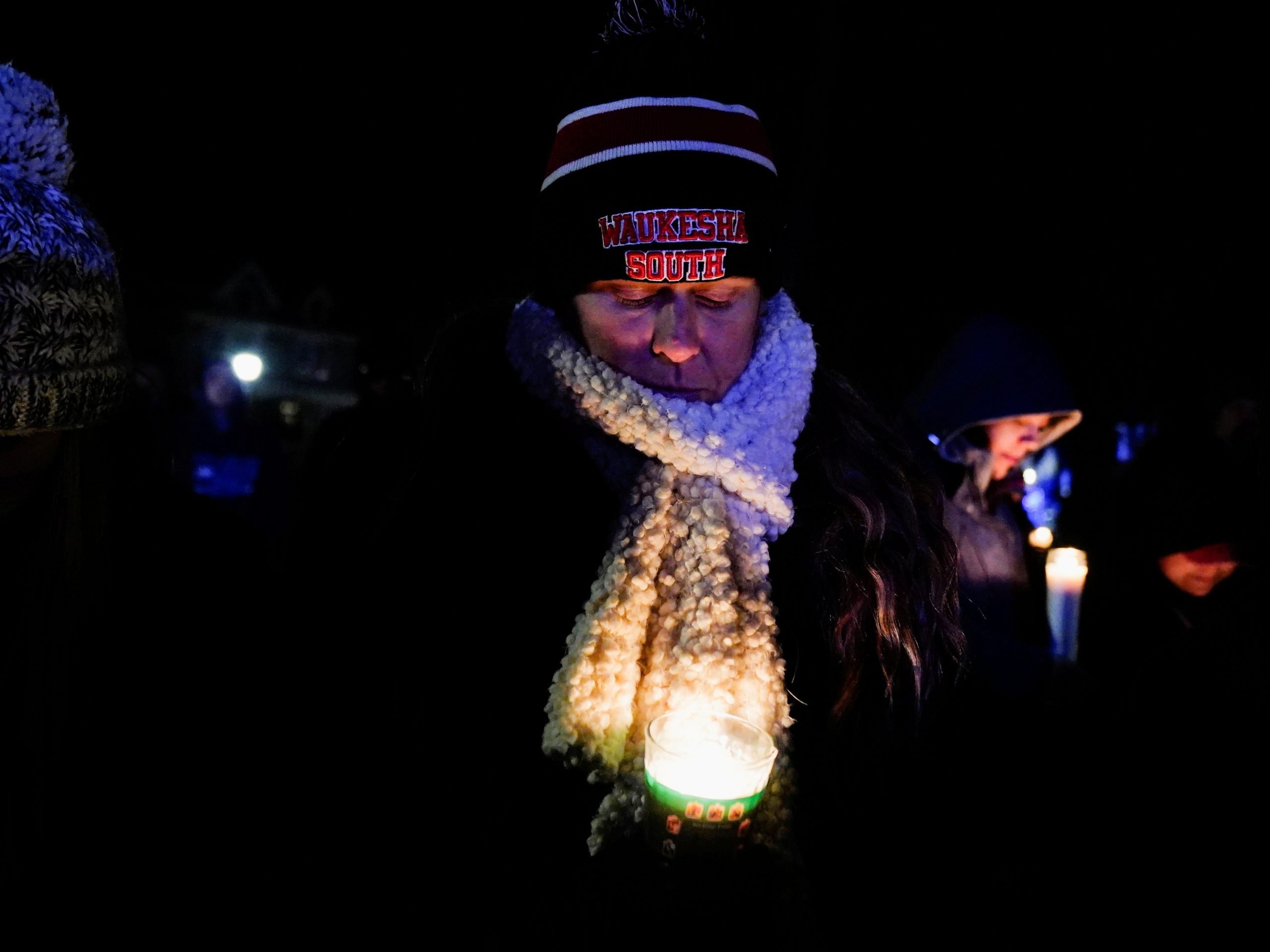 A woman at a vigil for victims of the Waukesha, Wisconsin, parade crash.