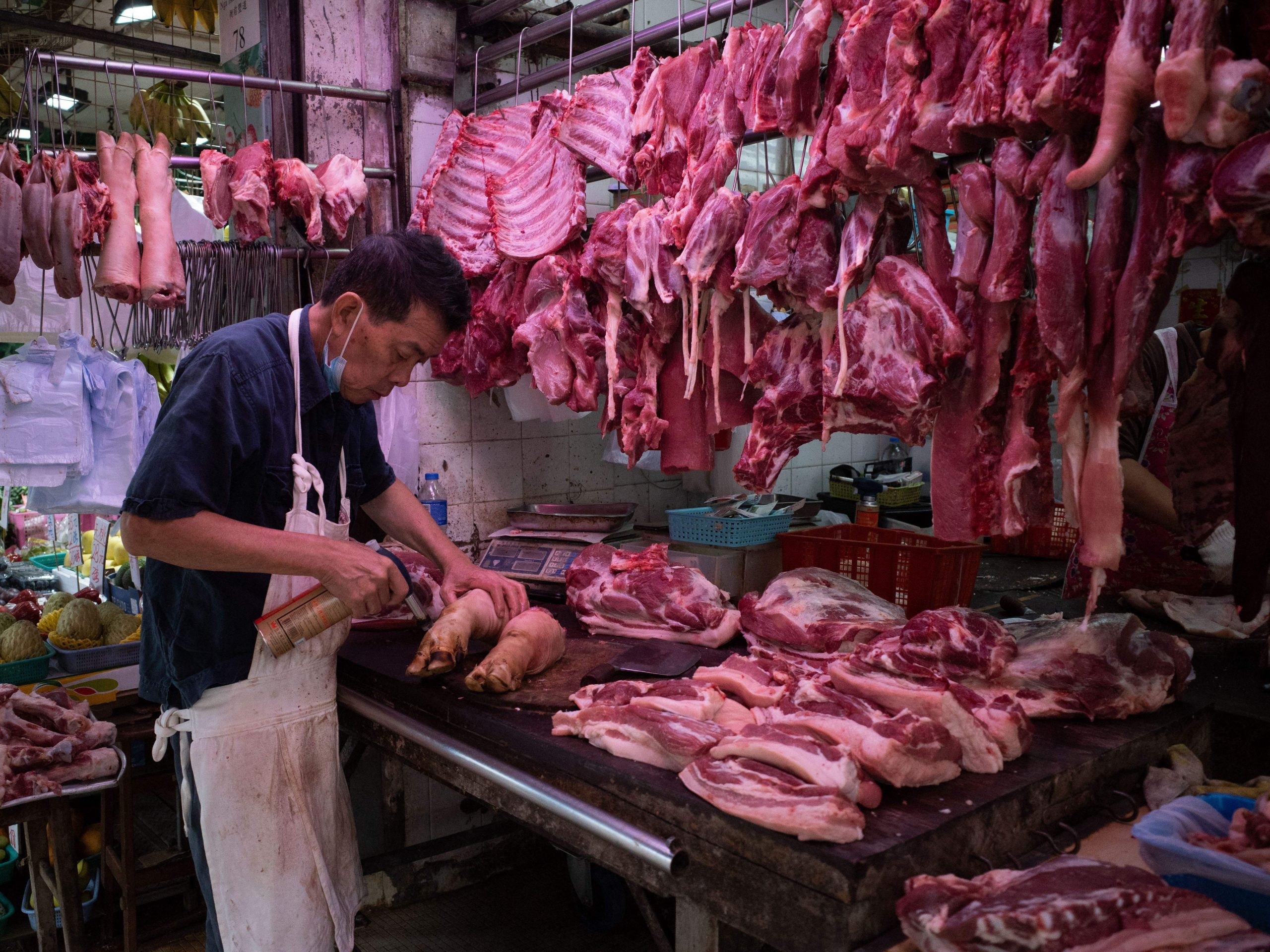 A butcher selling pork knuckles in Hong Kong