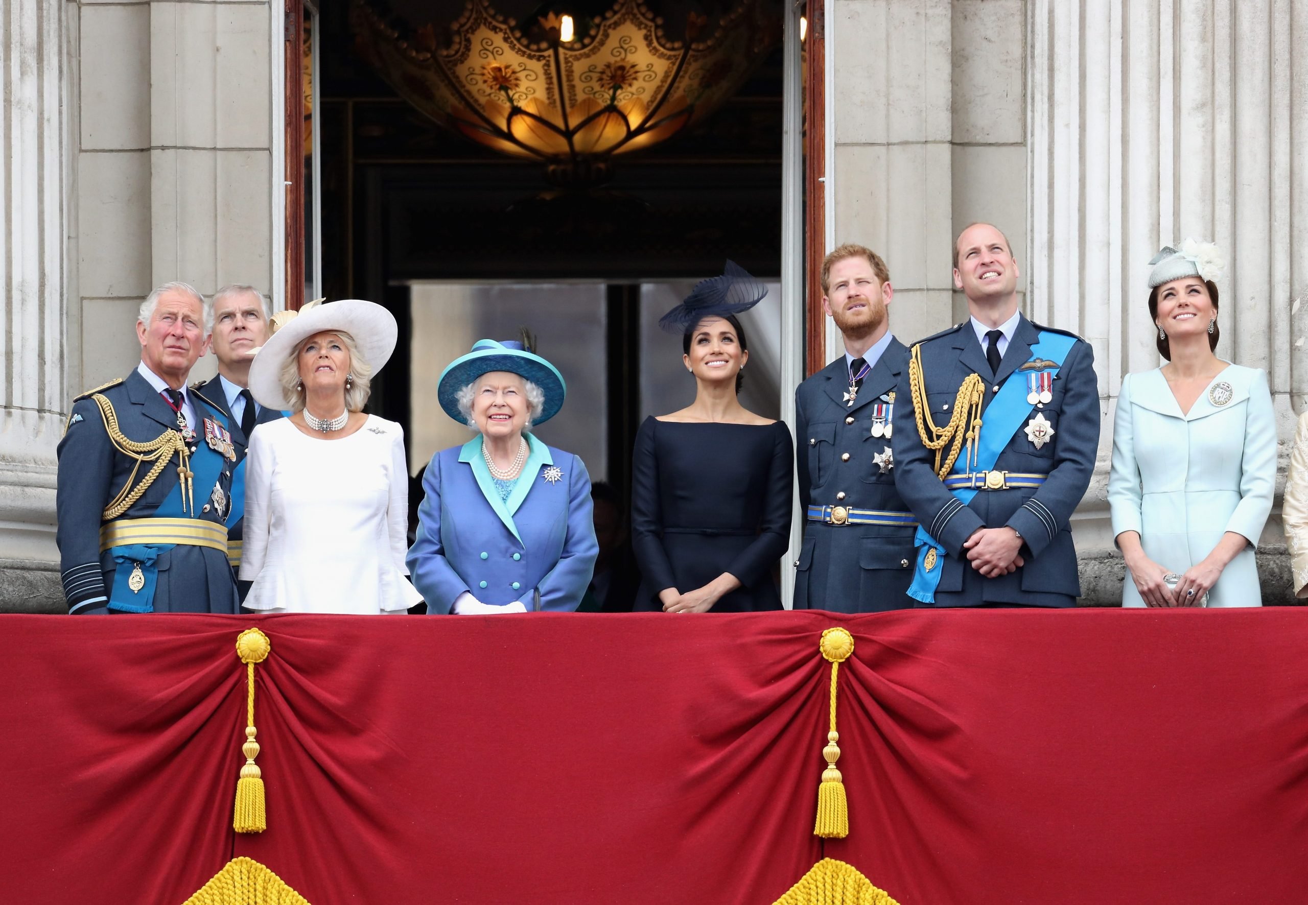 Prince Charles, Prince of Wales, Prince Andrew, Duke of York, Camilla, Duchess of Cornwall, Queen Elizabeth II, Meghan, Duchess of Sussex, Prince Harry, Duke of Sussex, Prince William, Duke of Cambridge and Catherine, Duchess of Cambridge watch the RAF flypast on the balcony of Buckingham Palace, as members of the Royal Family attend events to mark the centenary of the RAF on July 10, 2018 in London, England.