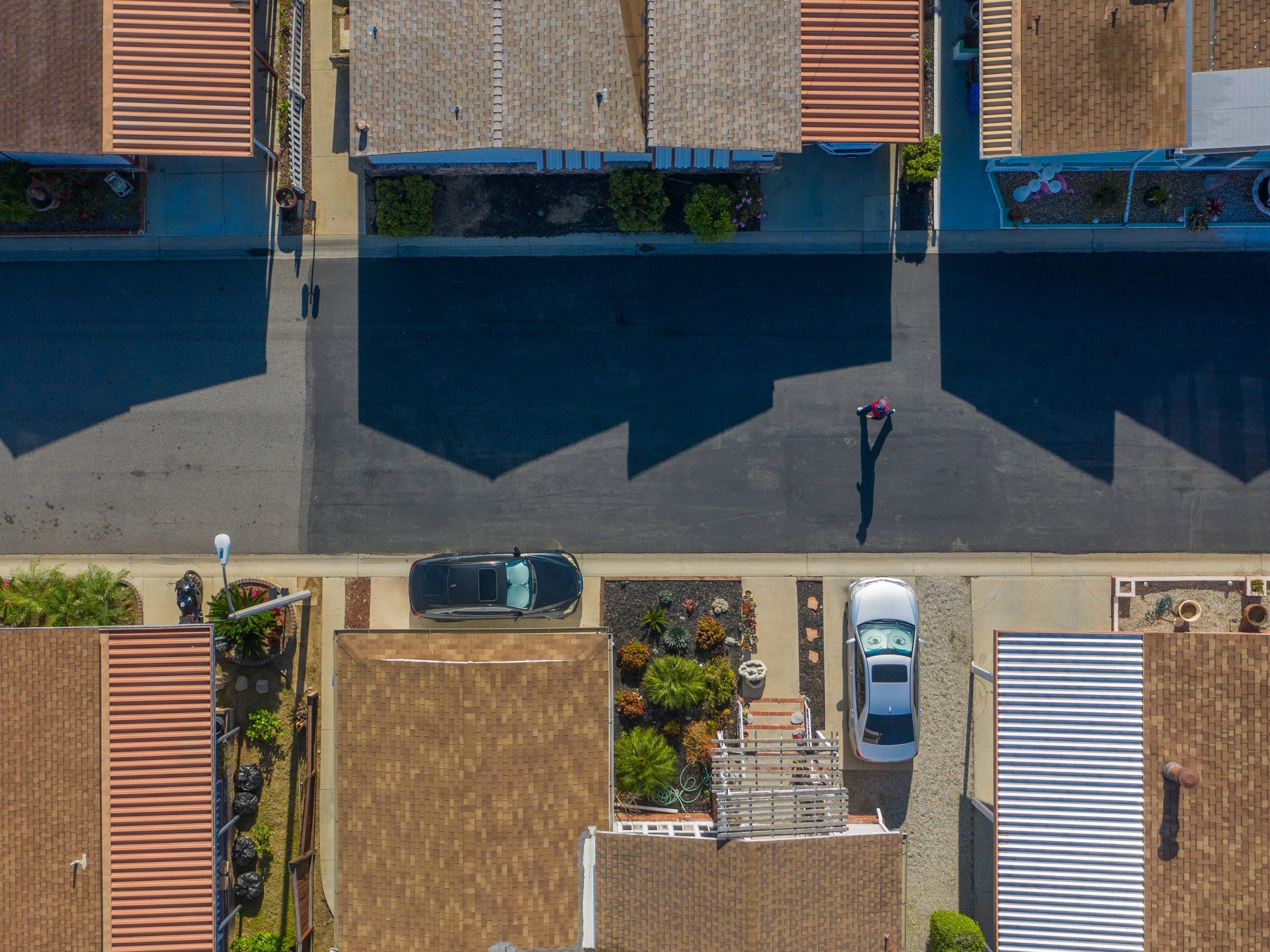 COMPTON, CALIFORNIA - APRIL 26: An aerial view shows a pedestrian on a quiet neighborhood street as residents continue to stay at home to fight the coronavirus pandemic on April 26, 2020 in the East Rancho Dominguez section of Compton, California on April 26, 2020. Los Angeles County has extend its stay-at-home order through at least May 15 and warned that restrictions could be extended into the summer. Officials have forecast that up to 30 percent of LA County residents could be infected by mid-summer without improvements to social distancing behavior. (Photo by David McNew/Getty Images)