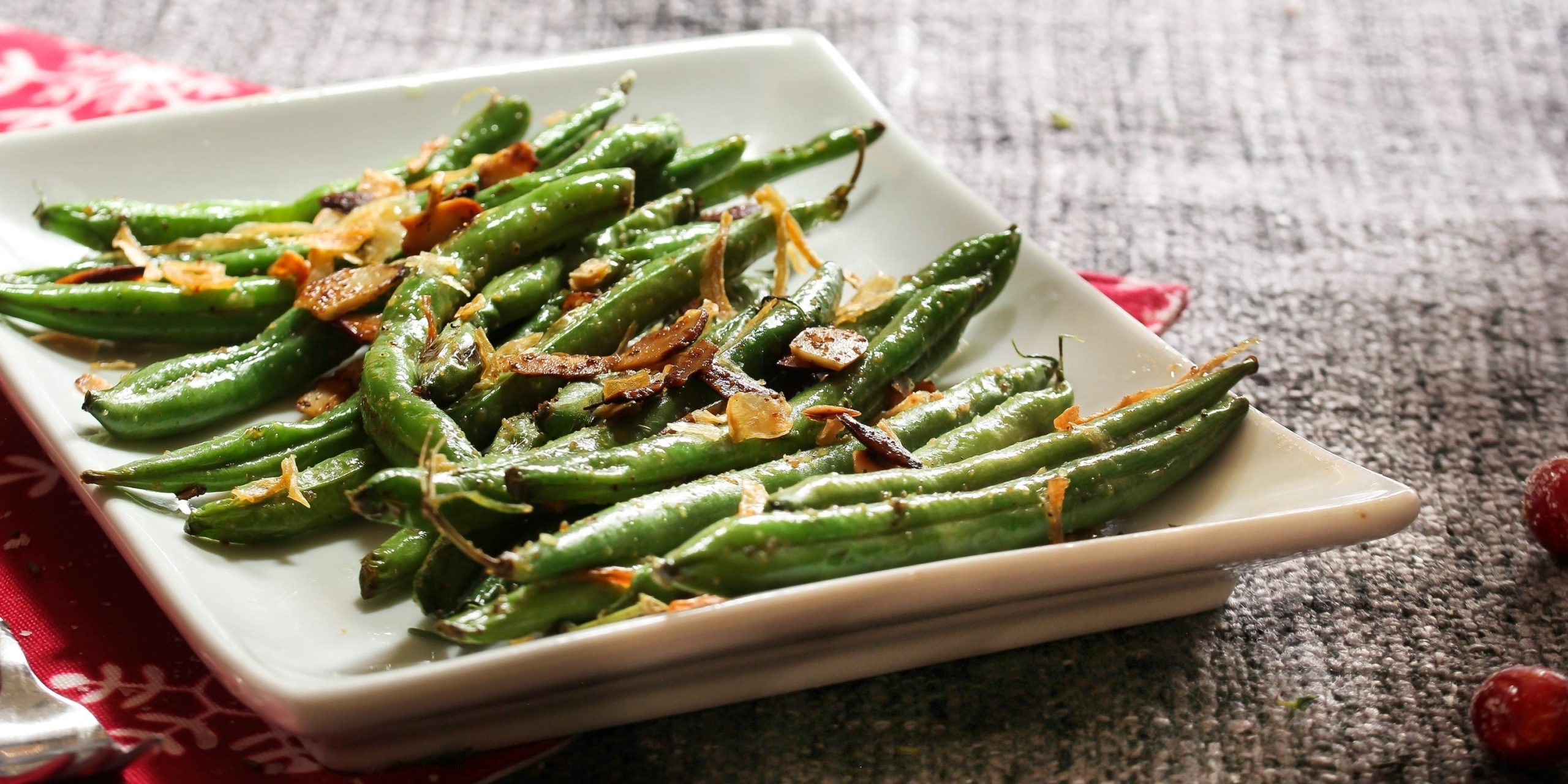 Roasted green beans topped with fried shallots and almonds.