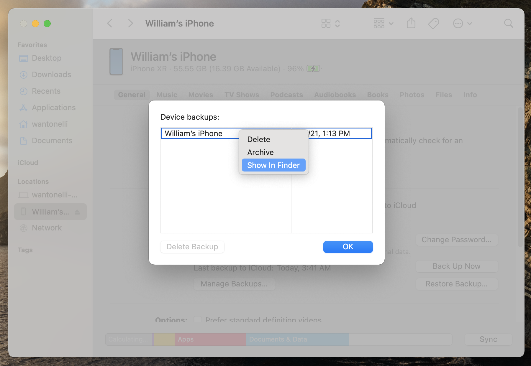 The menu on a Mac that lets you see all of your backups, with the "Show in Finder" option highlighted.