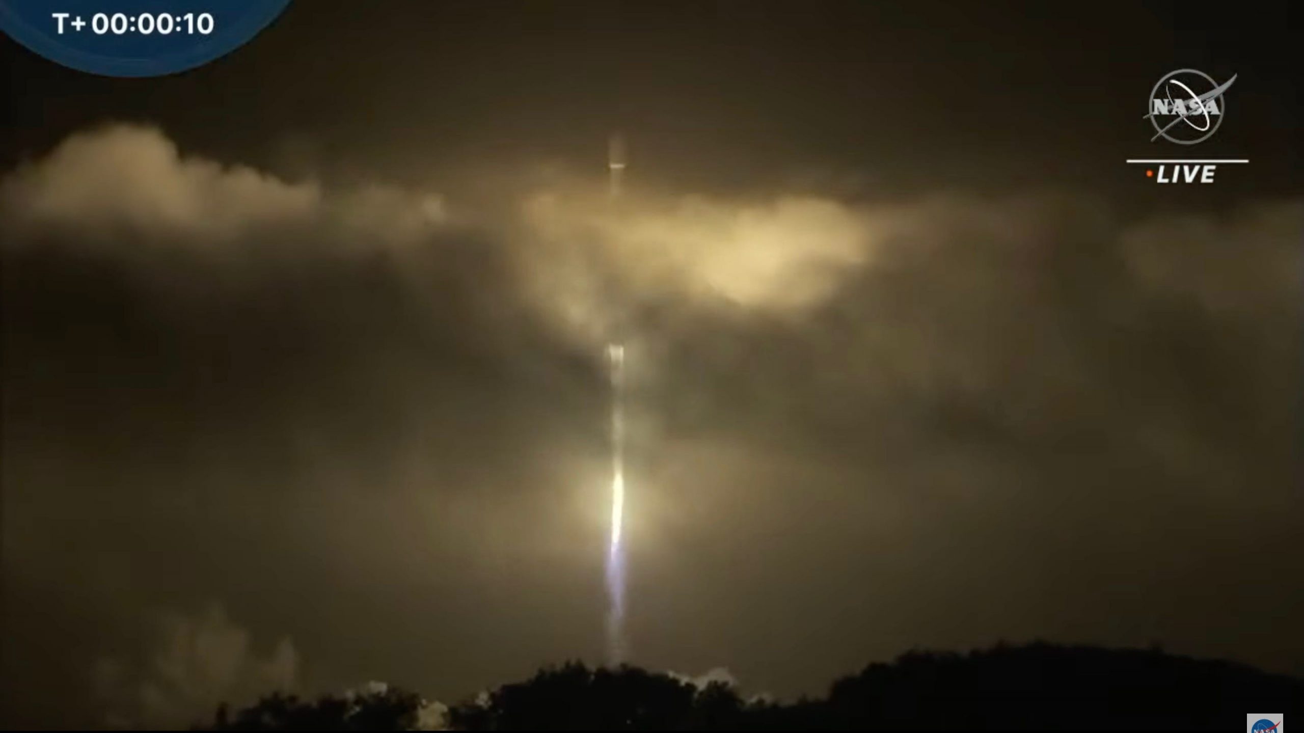 falcon 9 rocket lifting off at night with dart mission
