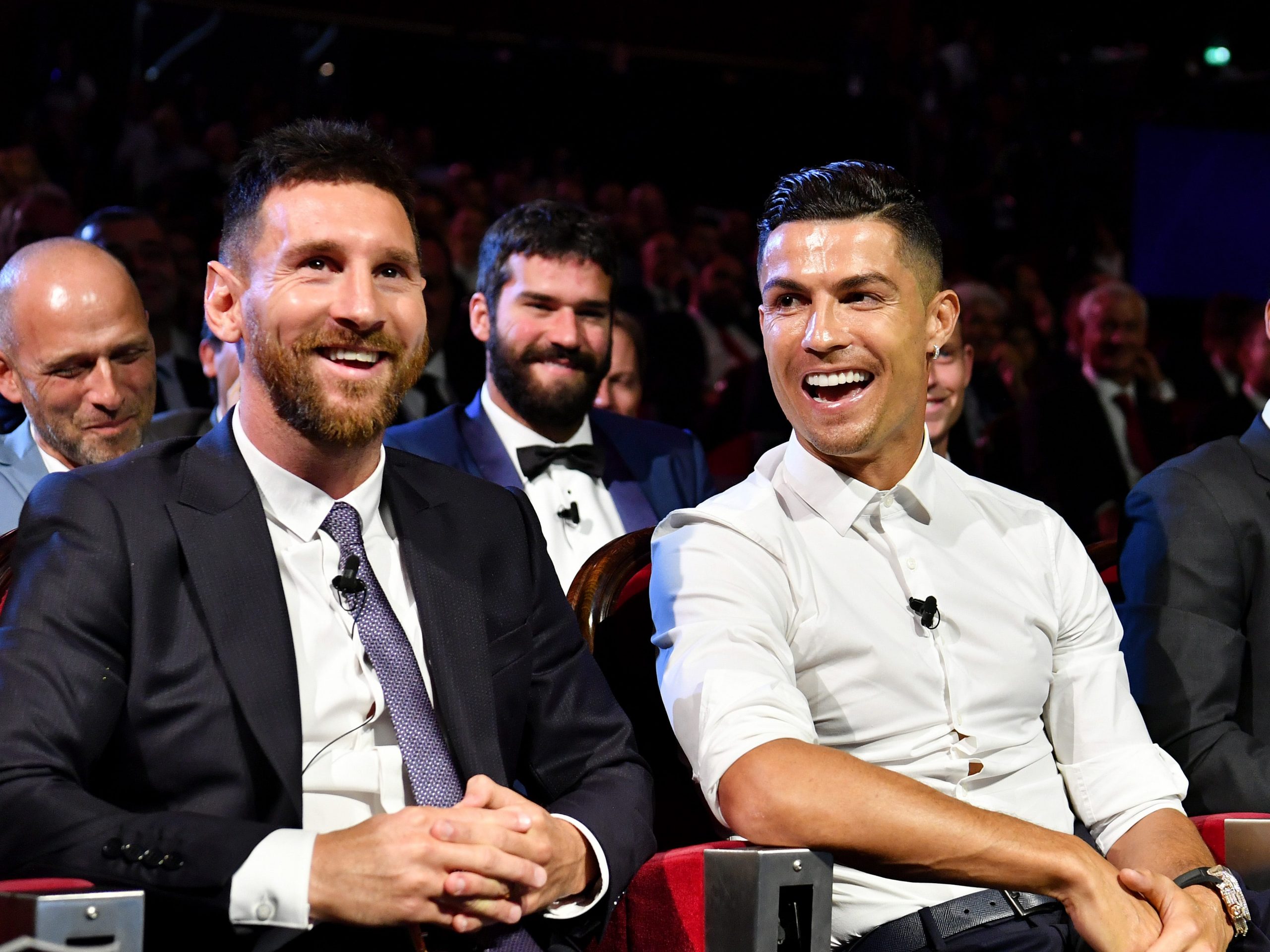 Lionel Messi and Cristiano Ronaldo laughing.