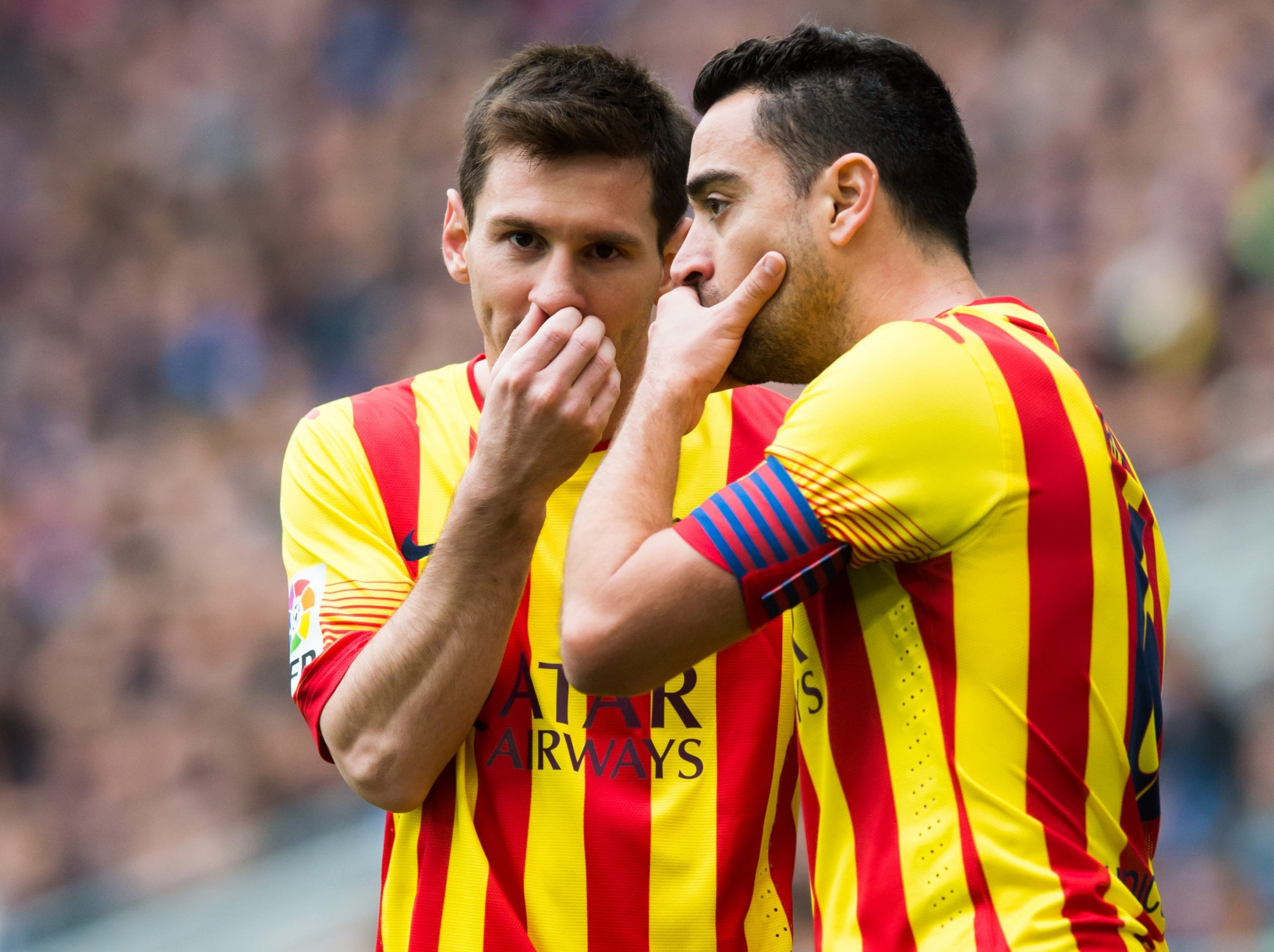 Lionel Messi speaks to Xavi.