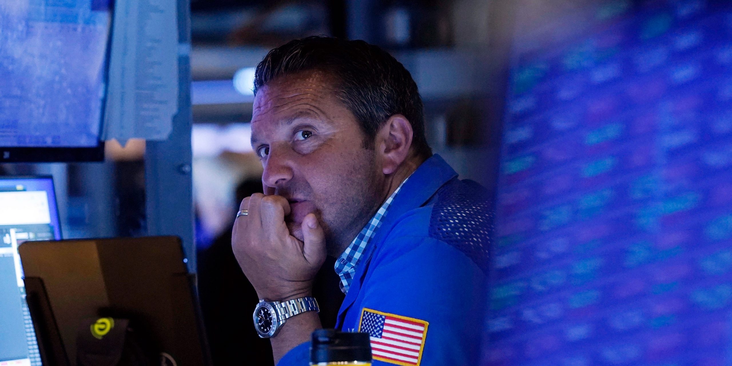 A trader sits in front of a computer monitor on the floor of the New York Stock Exchange.