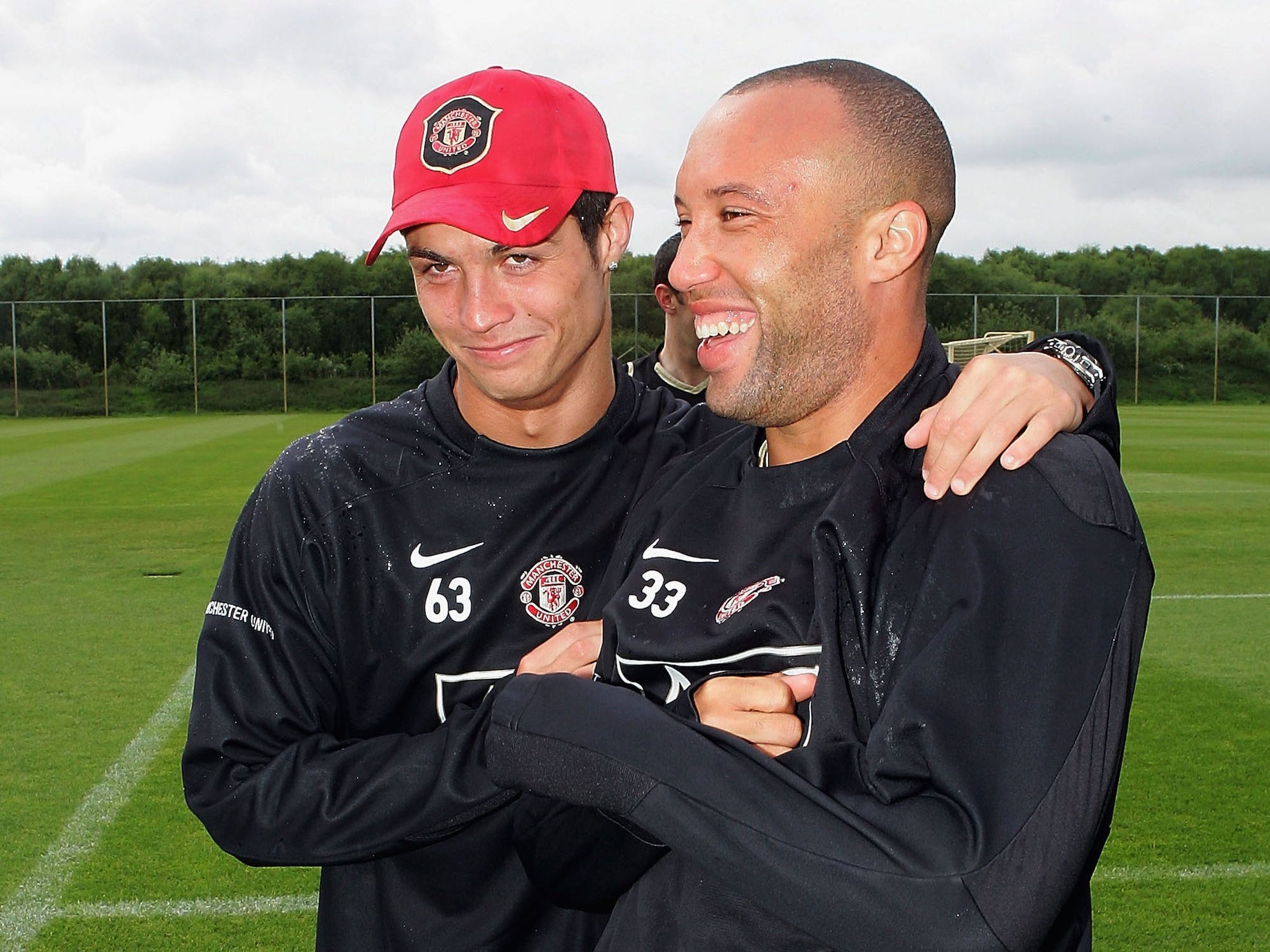 Cristiano Ronaldo and Mikael Silvestre of Manchester United celebrate winning the Premiership title during a first team training session at Carrington Training Ground