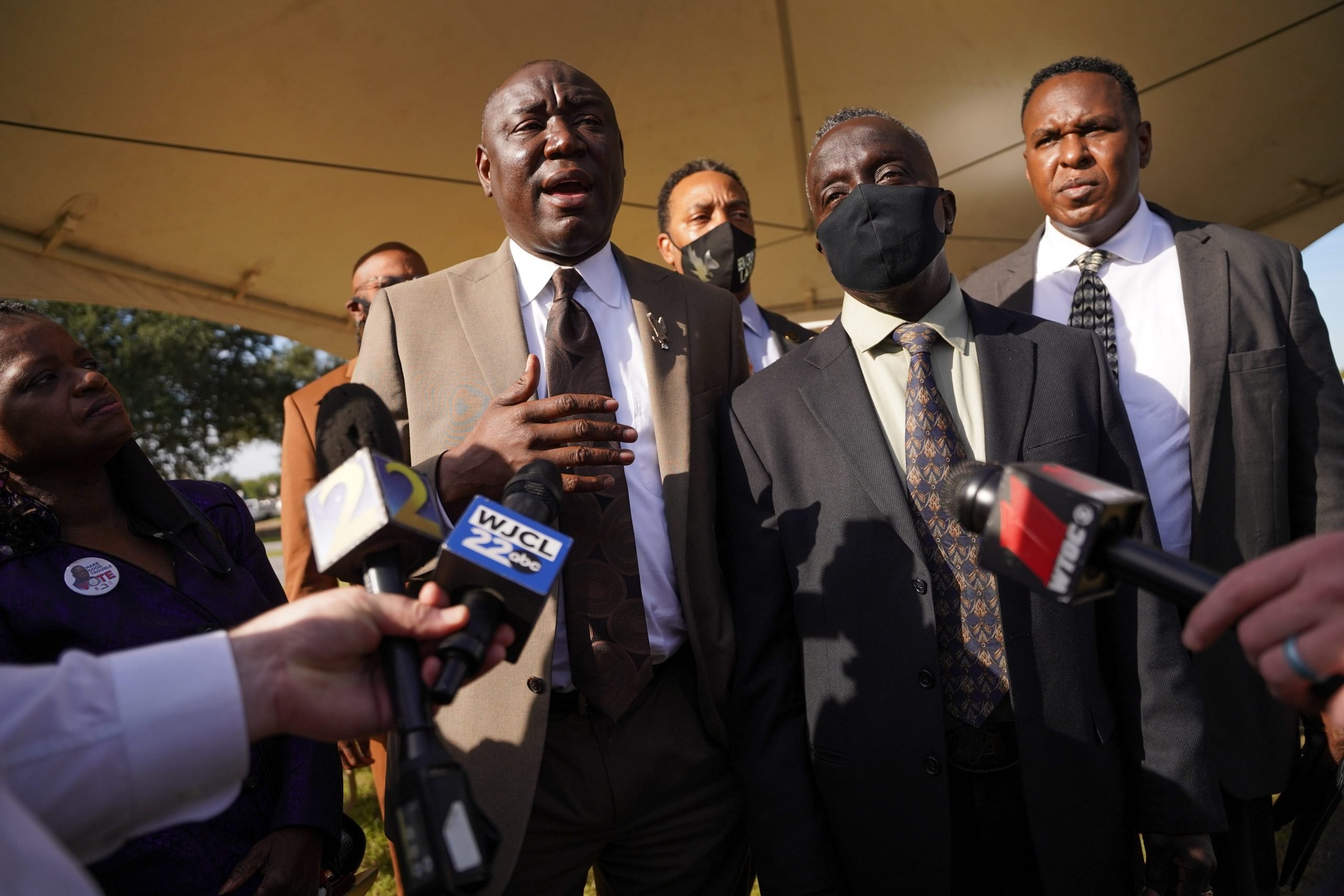 Attorney Ben Crump (L) and Marcus Arbery Sr., father of Ahmaud Arbery (2nd R) speak to members of the media outside the Glynn County Courthouse as jury selection begins in the trial of the shooting death of Ahmaud Arbery on October 18, 2021 in Brunswick, Georgia.