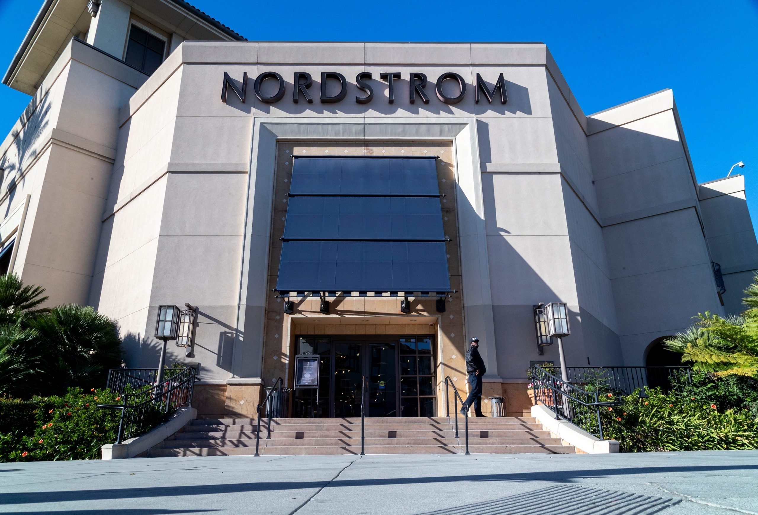 A security guard patrols the front entrance of Nordstrom on Tuesday after an organized group of thieves attempted a smash-and-grab robbery late Monday night at The Grove location November 23, 20201 in Los Angeles, California.