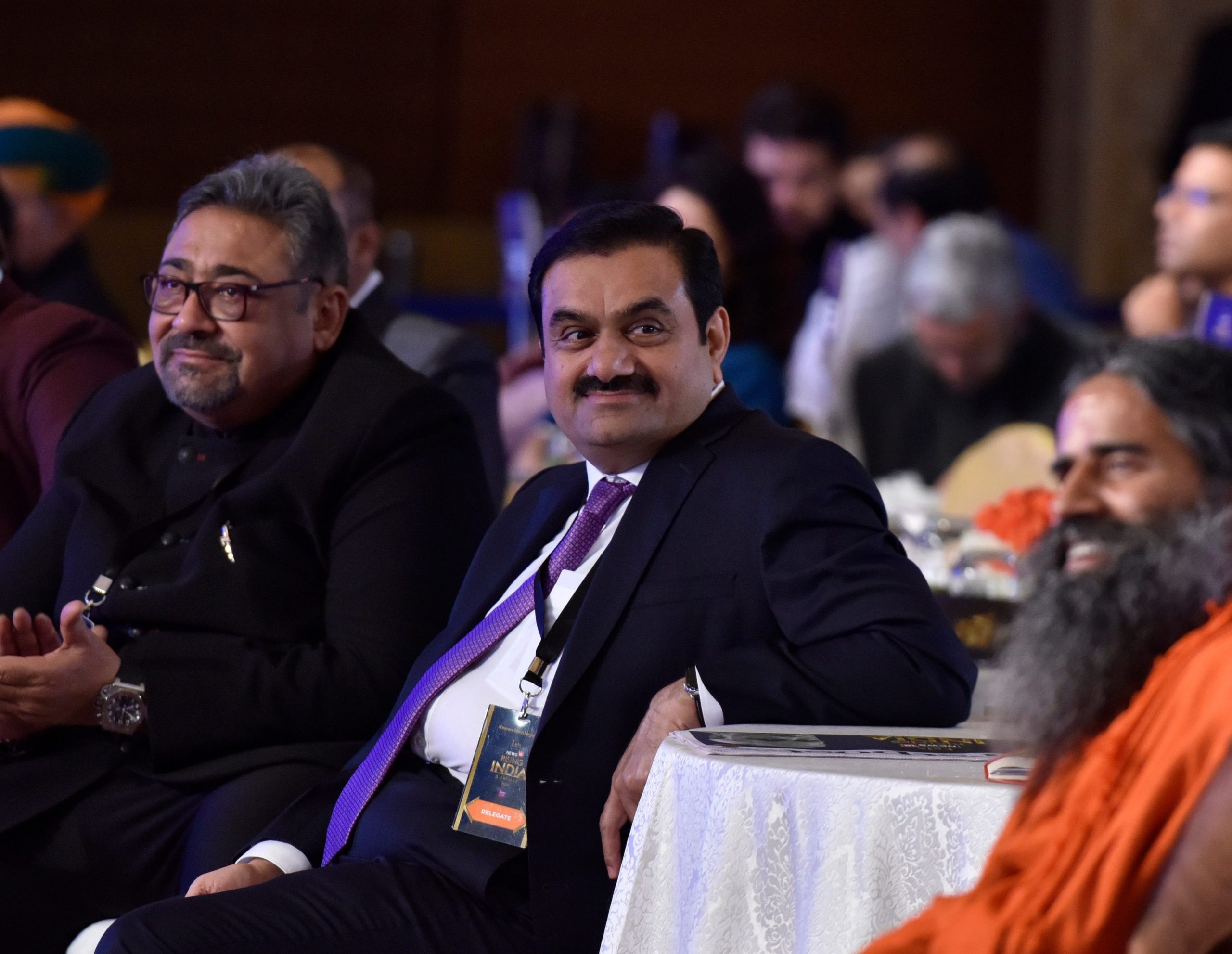 Gautam Adani sitting at a conference summit