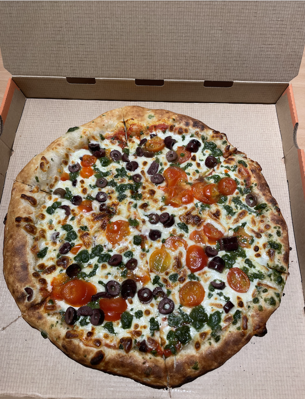 photo of pizza in cardboard box