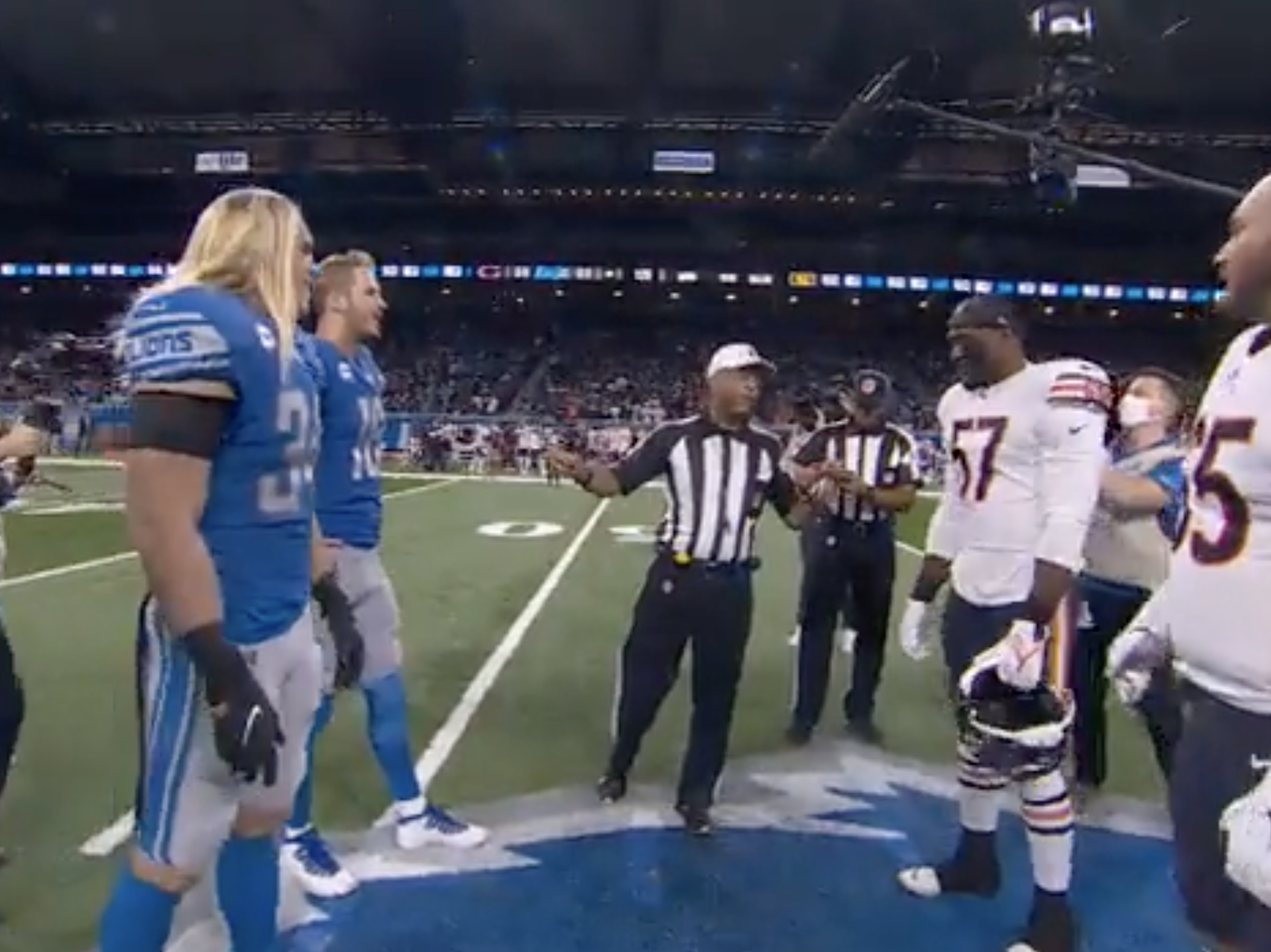 Lions and Bears players take part in coin toss ahead of Thanksgiving game.