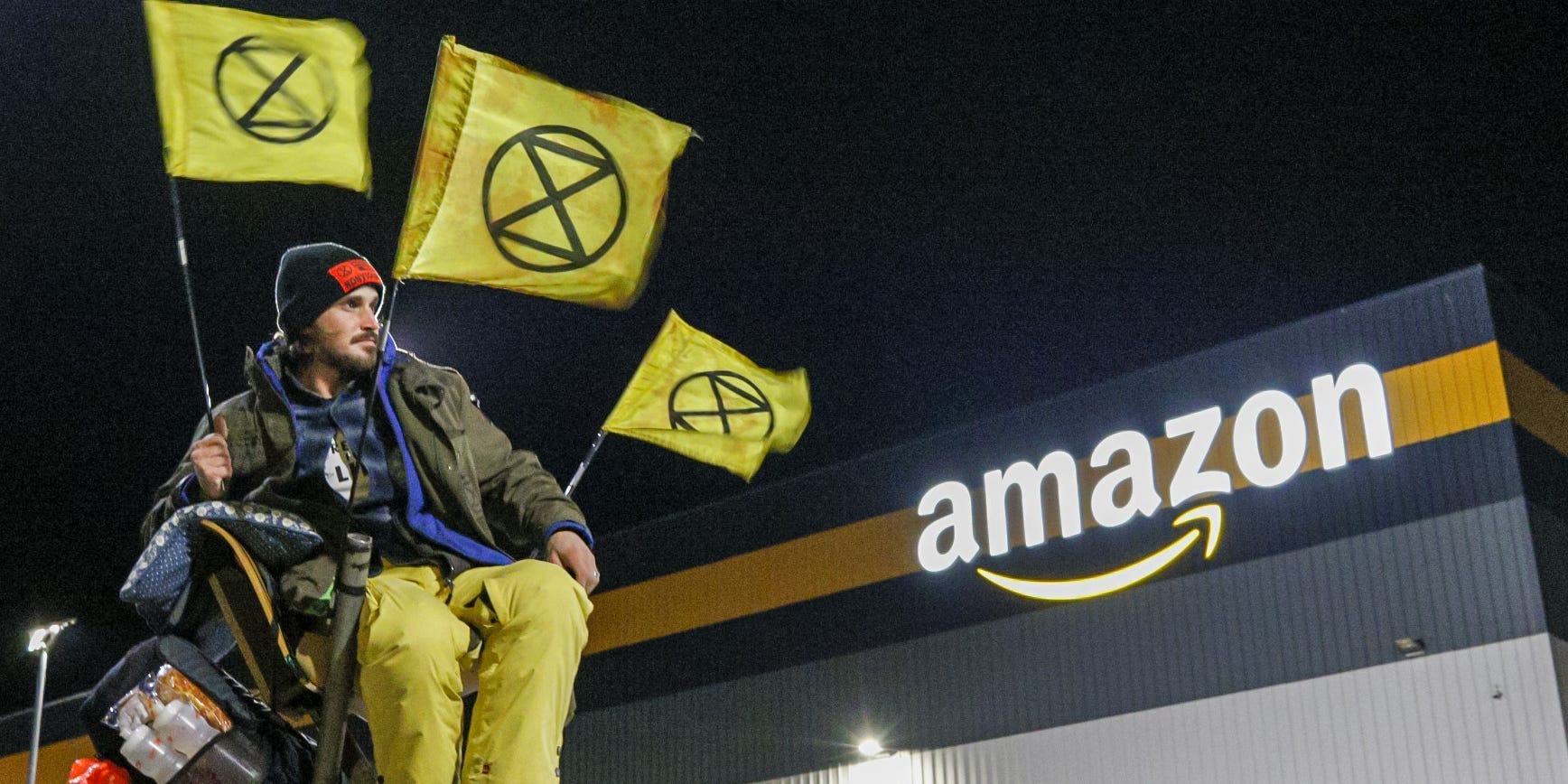 An Extinction Rebellion protester outside an Amazon warehouse.