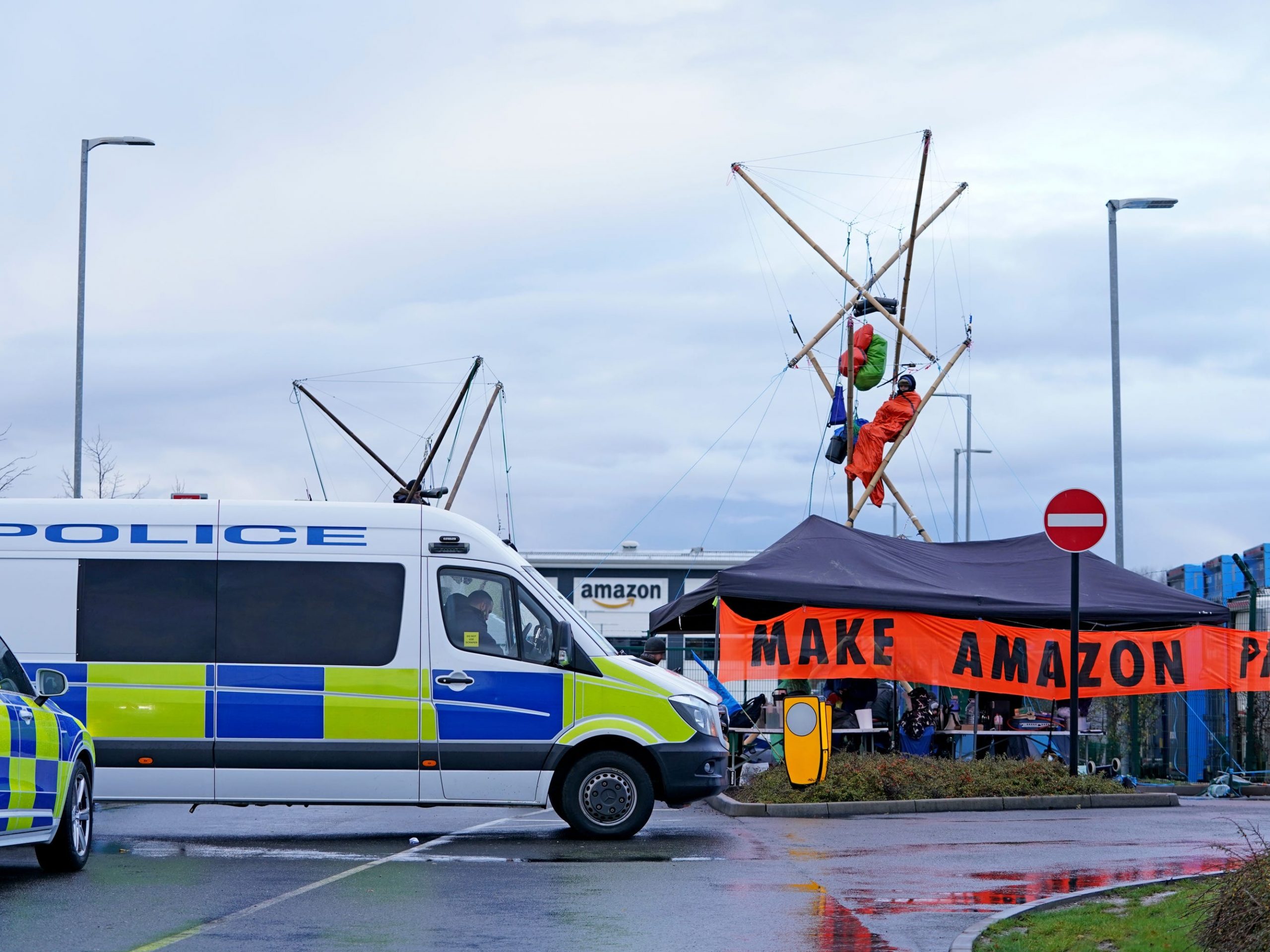 Activists from Extinction Rebellion block the entrance to the Amazon fulfilment centre in Coventry, preventing lorries from entering or leaving on Black Friday, the global retail giant's busiest day of the year.