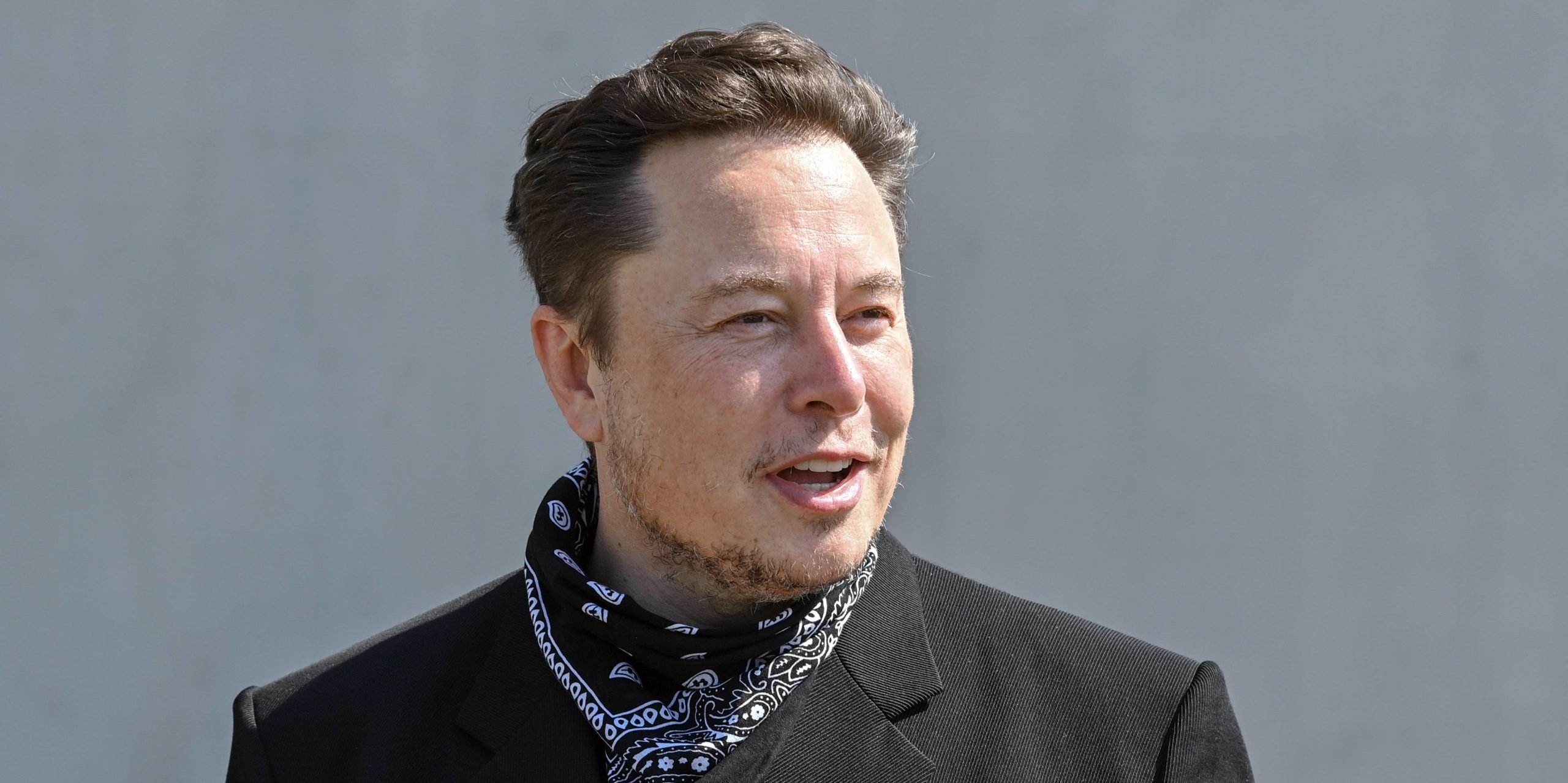 Elon Musk, Tesla CEO, stands at a press event on the grounds of the Tesla Gigafactory.