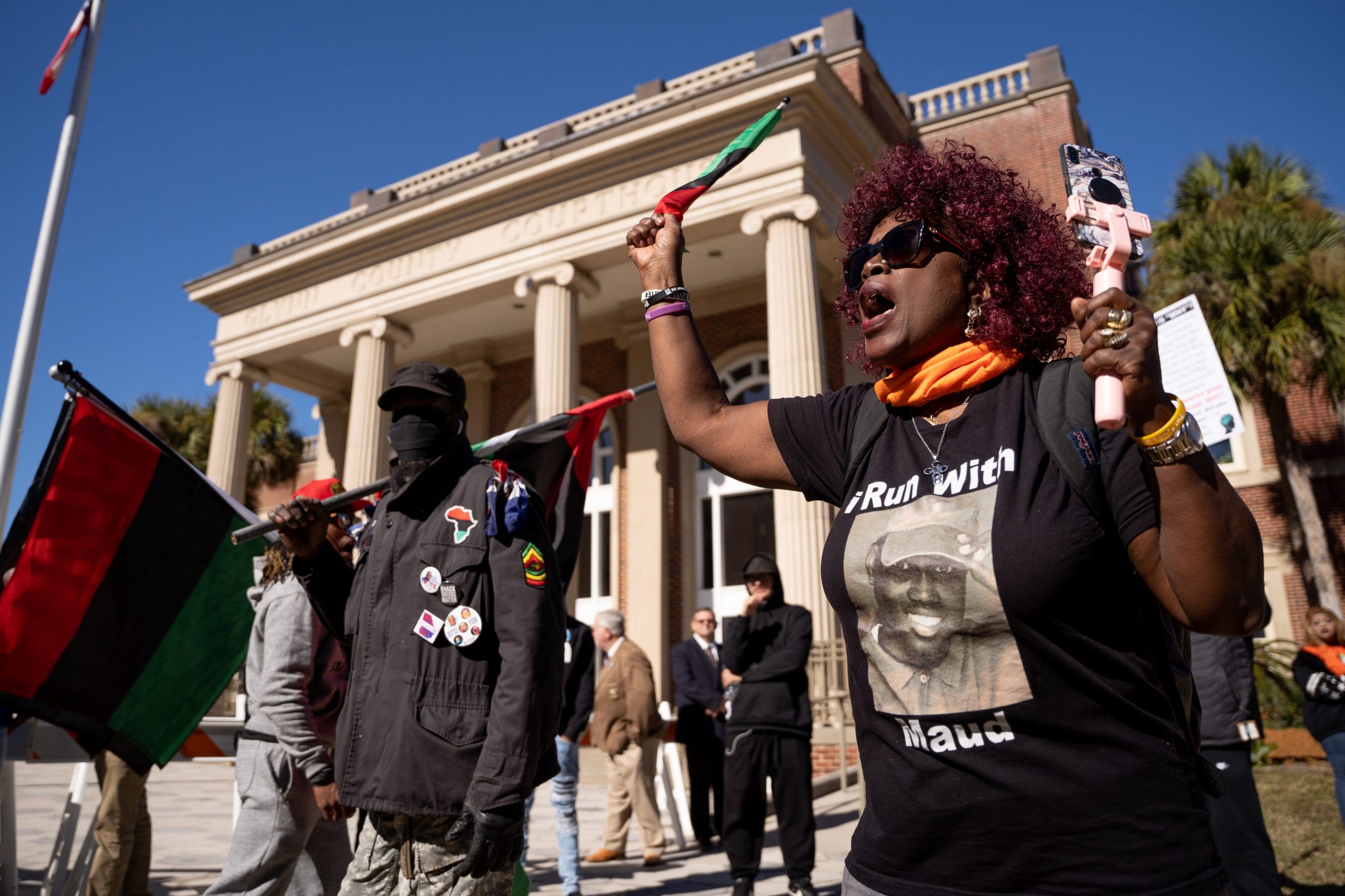 Carolyn Ruff demonstrates outside of the Glynn County Courthouse as jury deliberations begin in the trial of the killers of Ahmaud Arbery in Brunswick Georgia