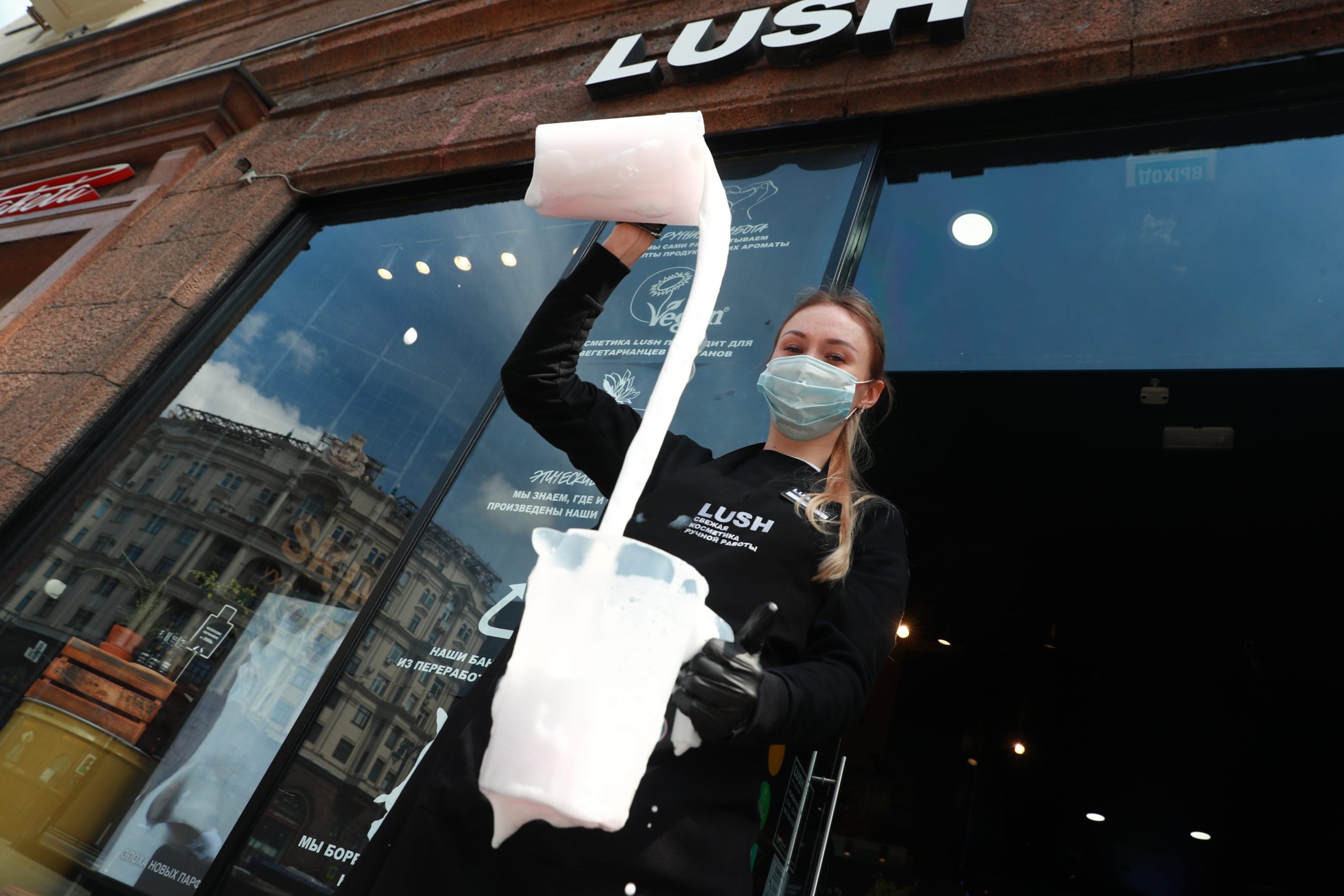 A woman mixing cosmetics outside a Lush store in Moscow, Russia.