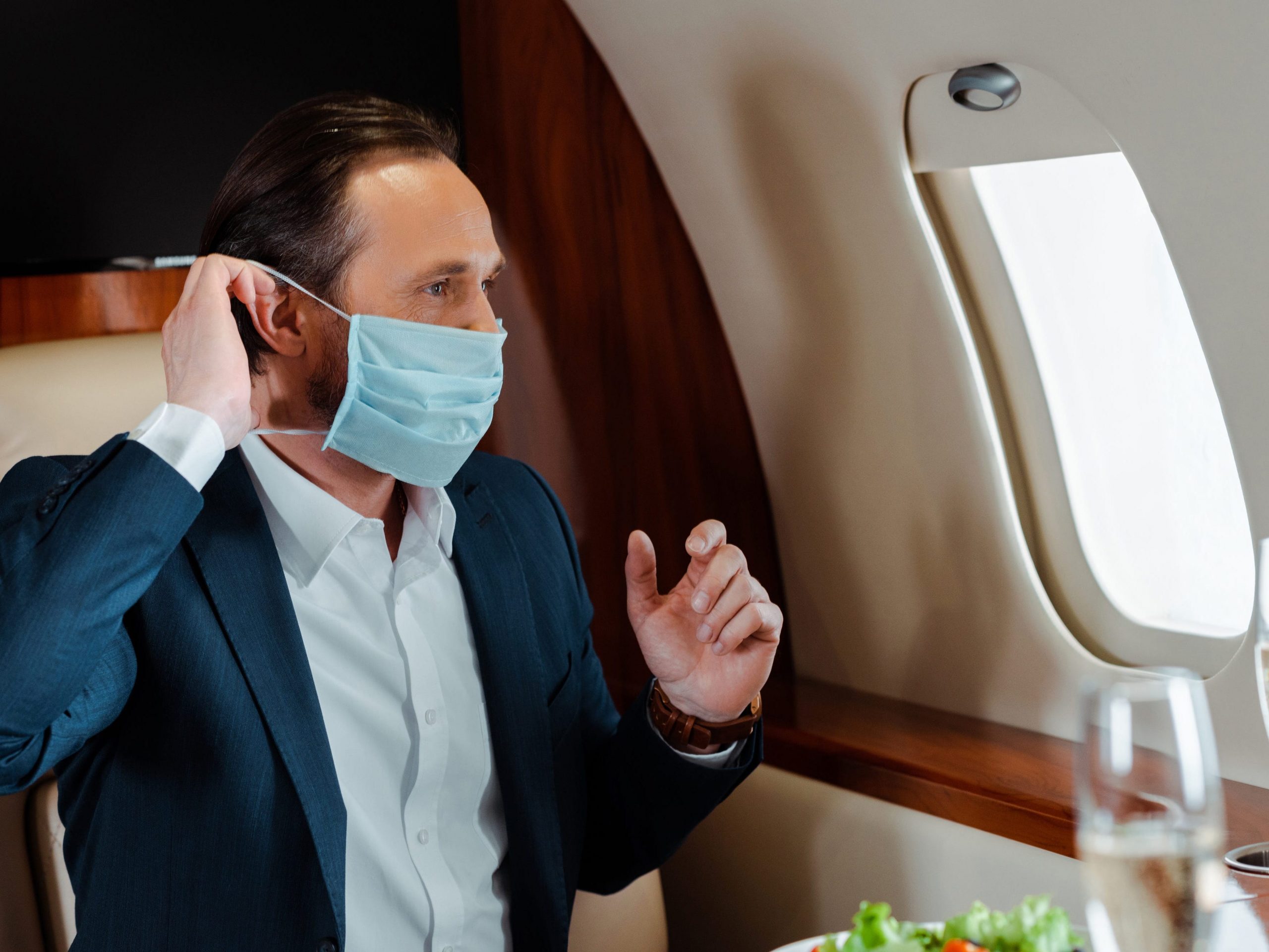 Private jet flyer wearing a mask