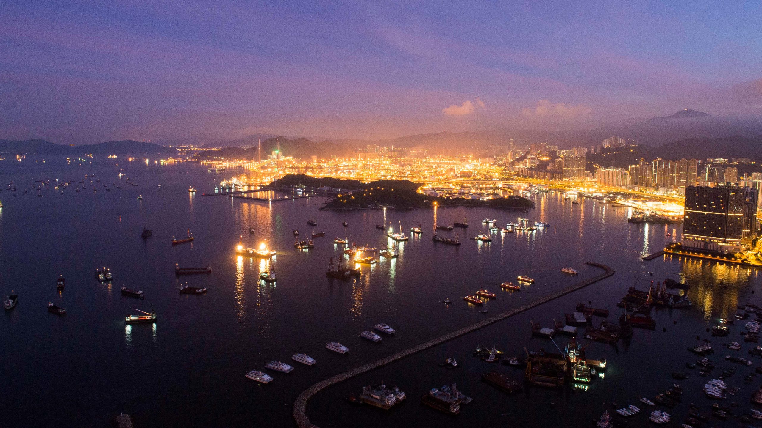 nighttime view of Hong Kong's Tsing Yi district and Tsing Ma Bridge with Stonecutters Island in foreground