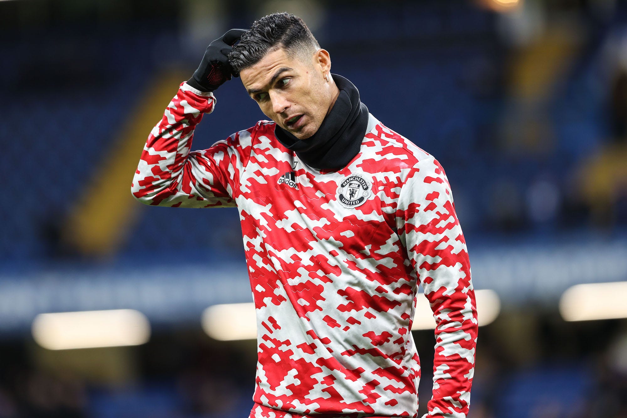 Cristiano Ronaldo of Man Utd scotches his head ahead of the Premier League match between Chelsea and Manchester United at Stamford Bridge