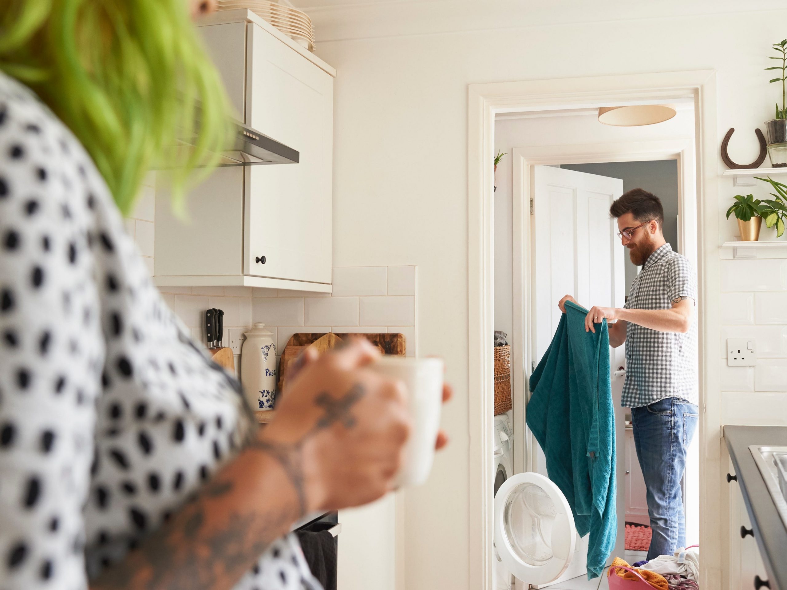 Young hipster couple doing their laundry