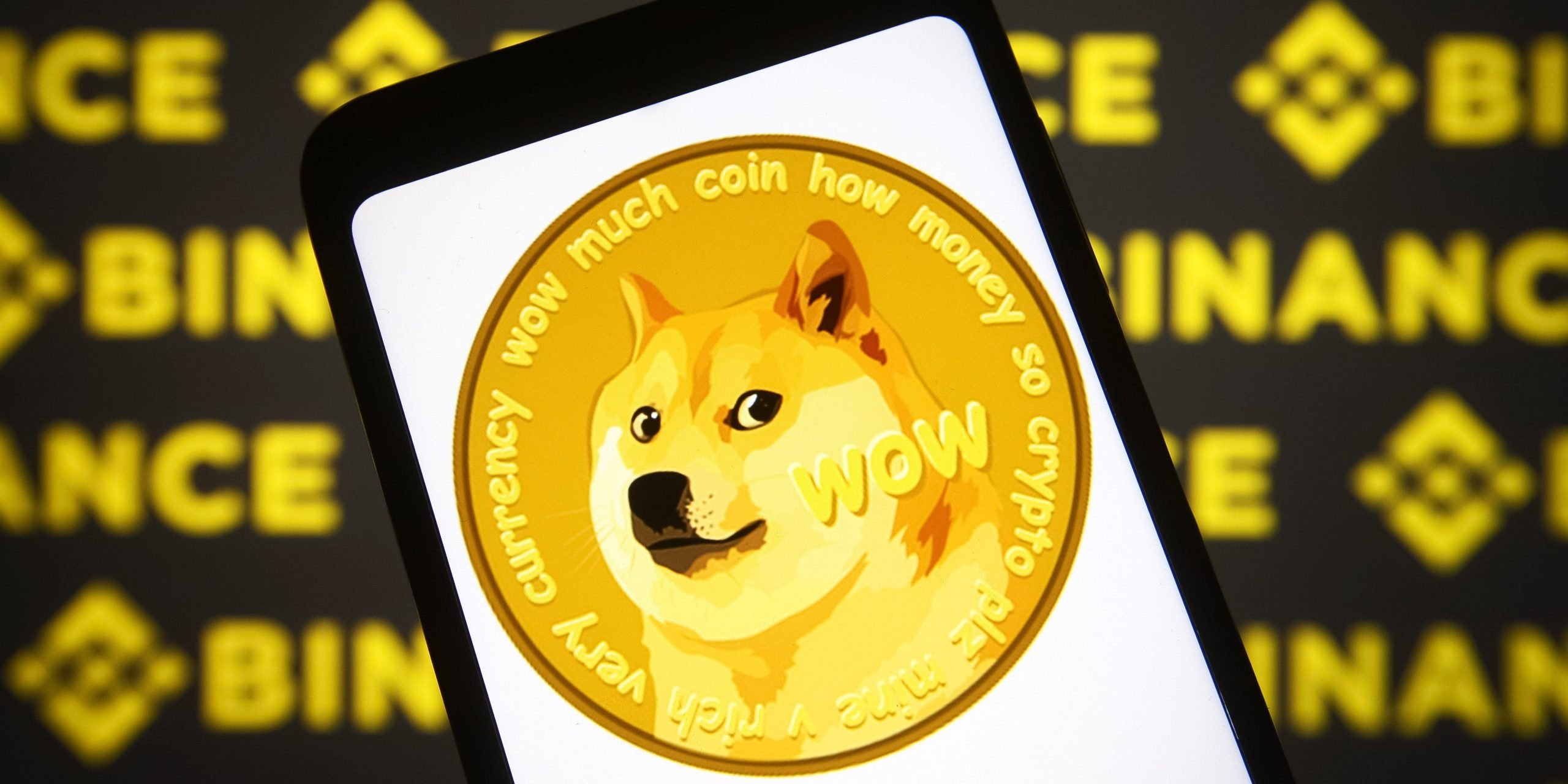 In this photo illustration, a Dogecoin sign of a cryptocurrency is seen on a smartphone screen with a Binance logo of a cryptocurrency exchange in the background.