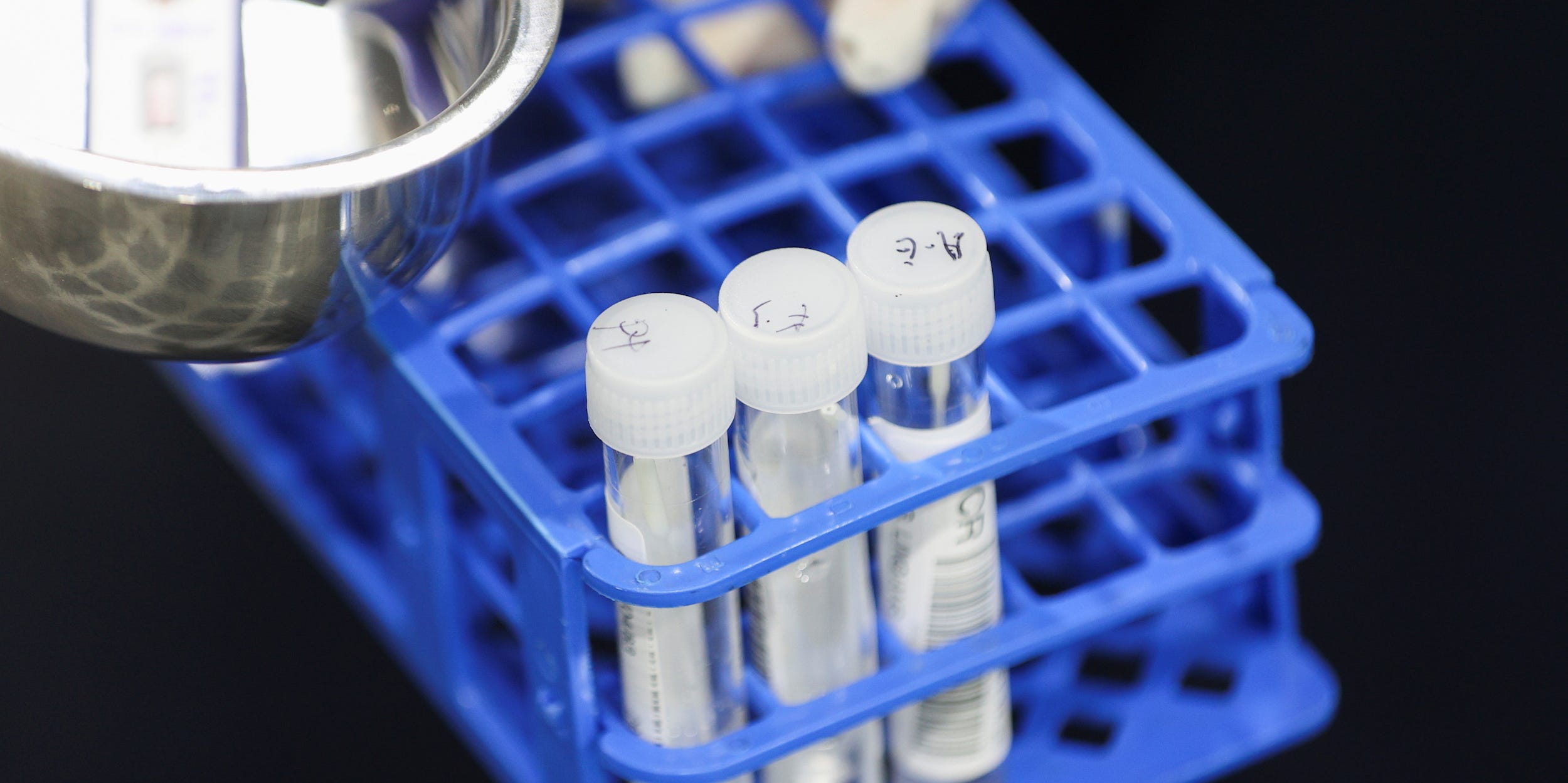 A medical worker carries RT-PCR swab tests at a pre-departure coronavirus disease (COVID-19) testing facility, as countries react to the new coronavirus Omicron variant, outside the international terminal at Sydney Airport in Sydney, Australia, November 29, 2021.