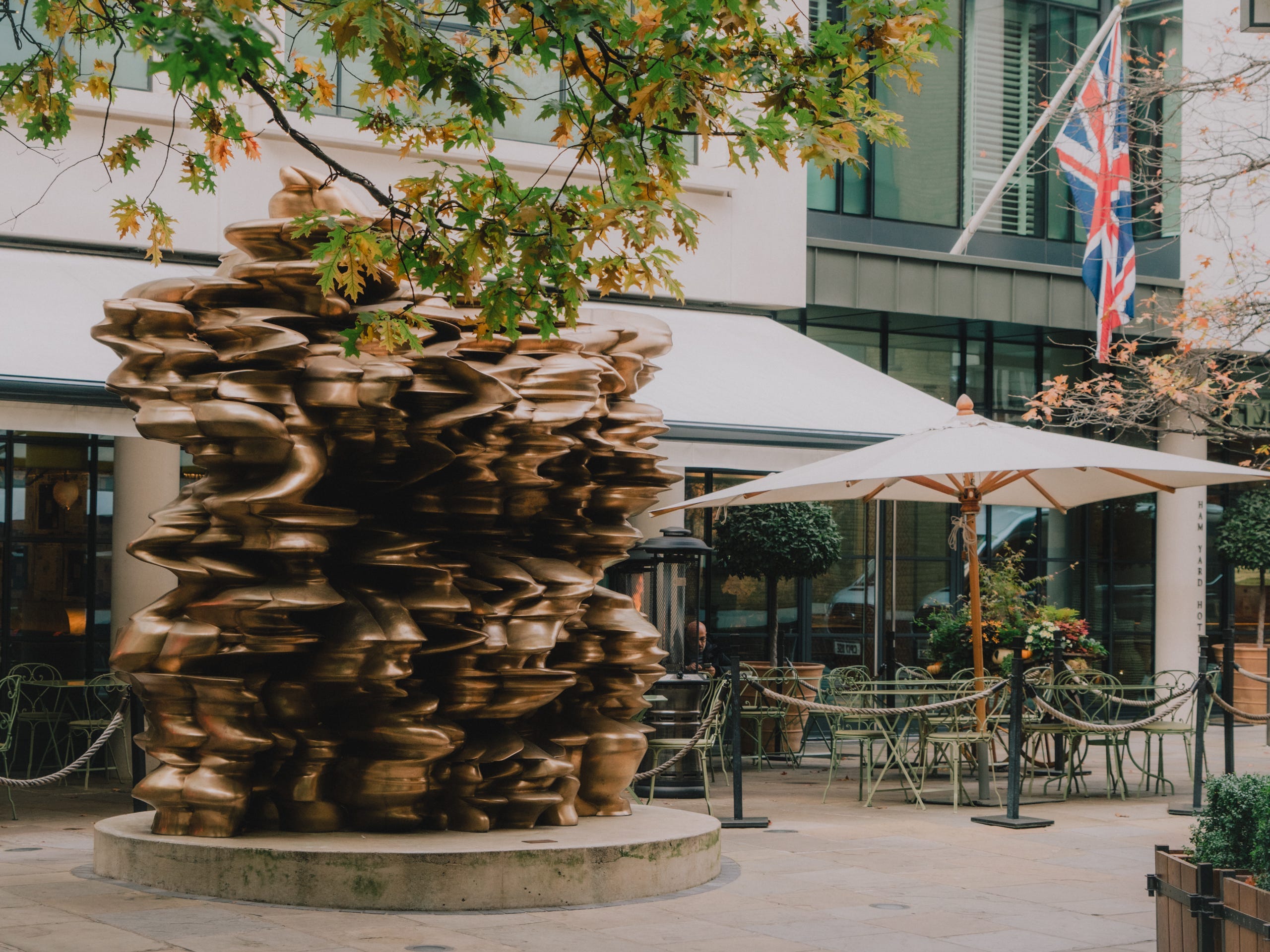 The exterior of the Ham Yard Hotel in London with a sculpture.