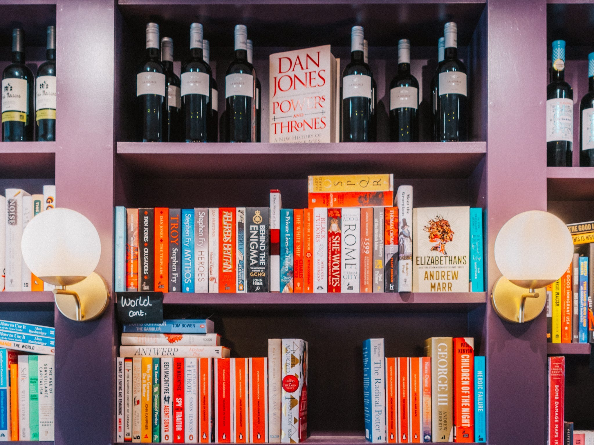 Rows of books and bottles of wine at BookBar in London.