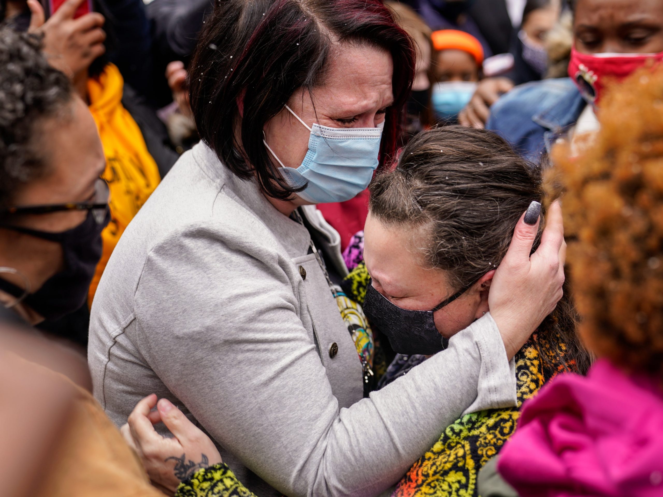 Courtney Ross, girlfriend of the deceased George Floyd, left, hugs Katie Wright, mother of the deceased Daunte Wright, right, before a news conference, Tuesday, April 13, 2021, in Minneapolis.