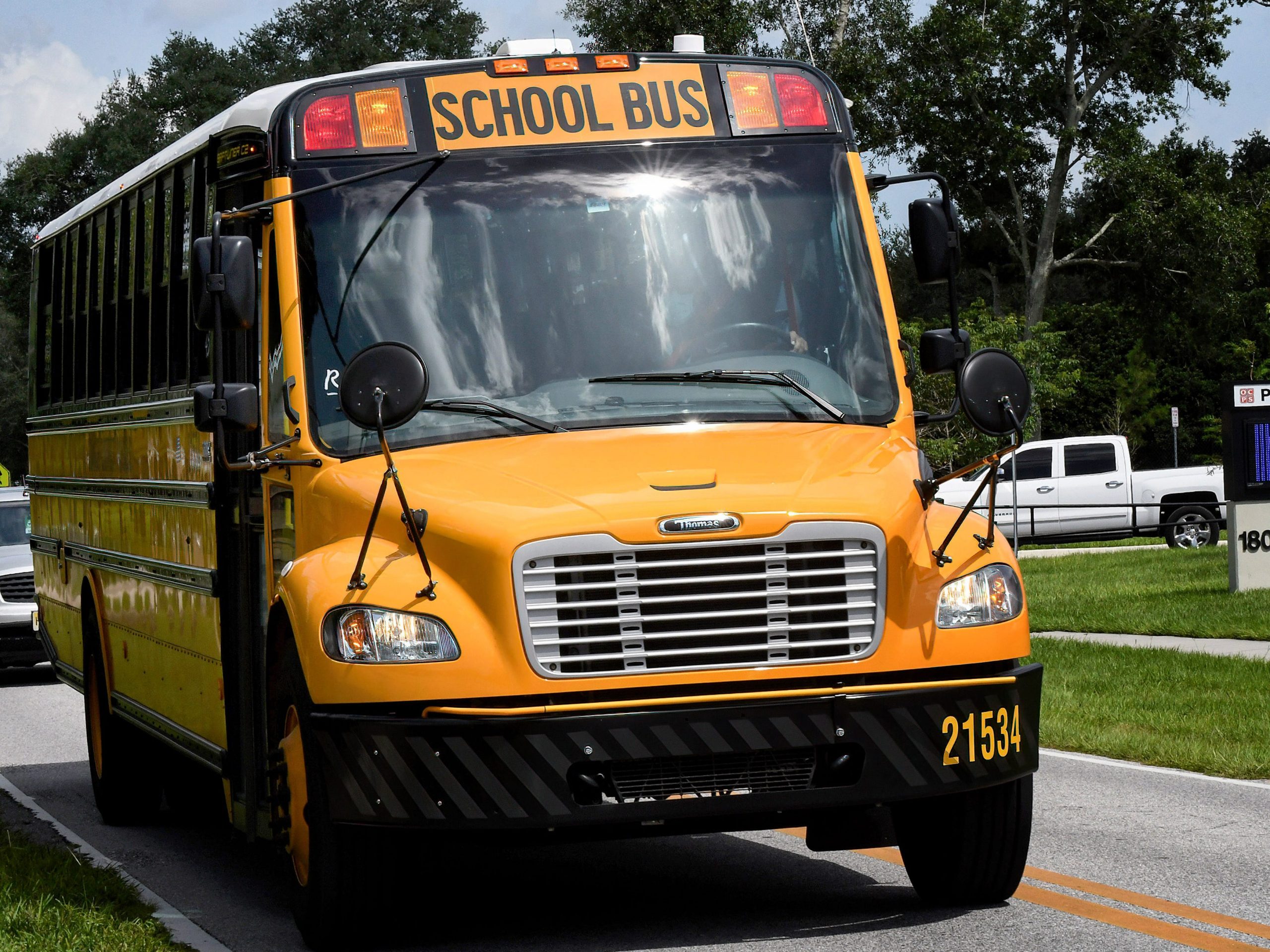 A school bus drives past Pershing School in Orlando.