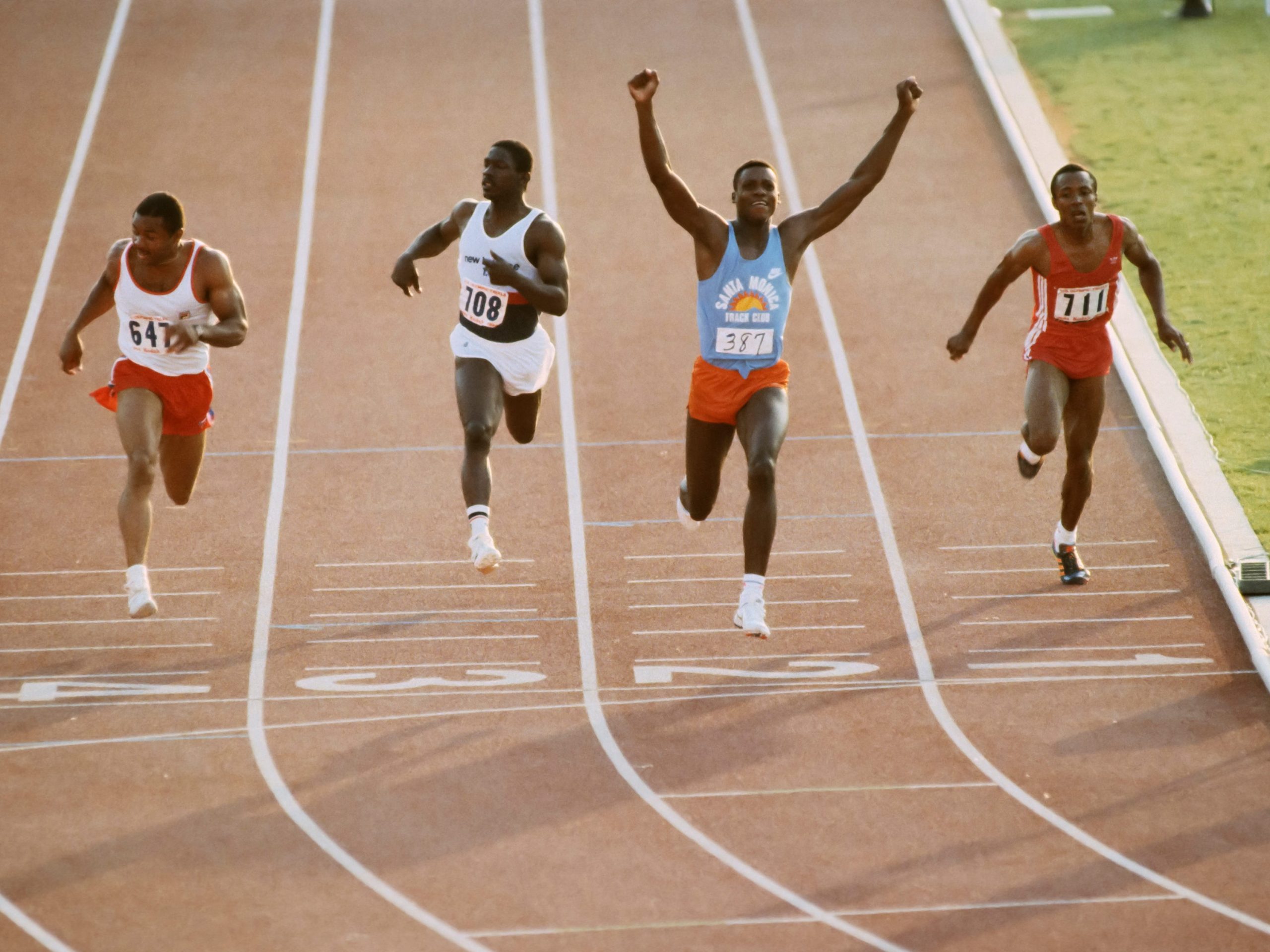 Carl Lewis #387 wins the final of the Men's 100m event during 1984 United States Olympic Track and Field Trials