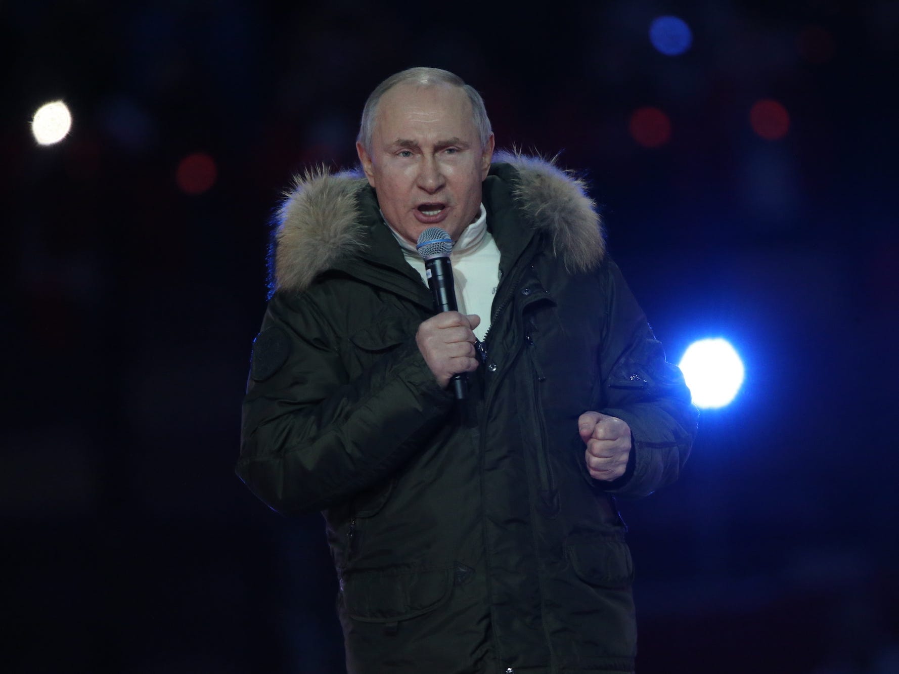 Russian President Vladimir Putin speaking into a microphone.